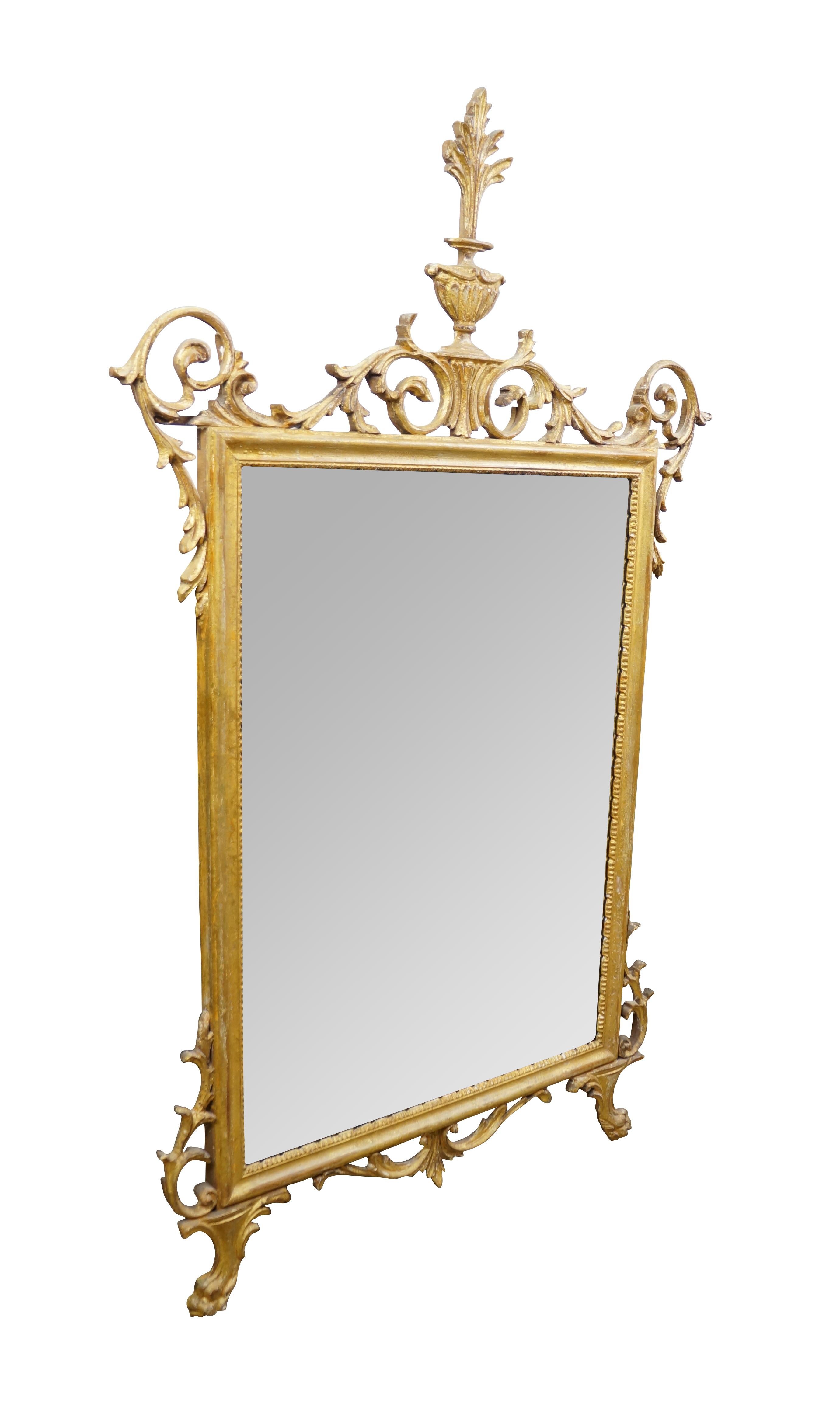 Circa mid 20th century La Barge number 1628B giltwood beveled glass wall mirror, featuring Italian Hollywood Regency / Neoclassical styling with delicate scrolling acanthus foliate crest and corners, paw feet, and manel urn.

Dimensions:
32