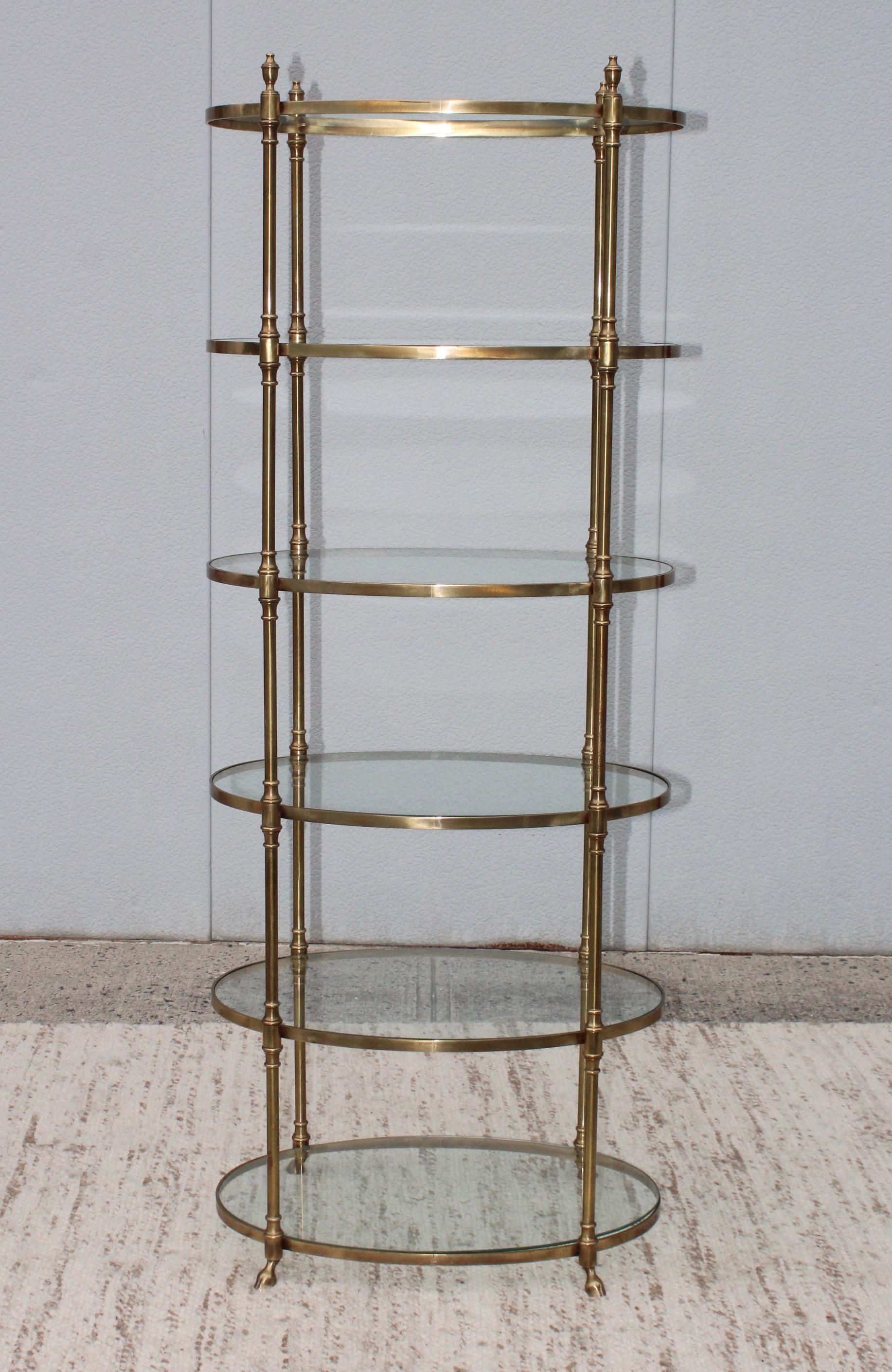 Stunning 1960s oval shape 6 shelves brass Etagere by La Barge. With hoof feet detail.