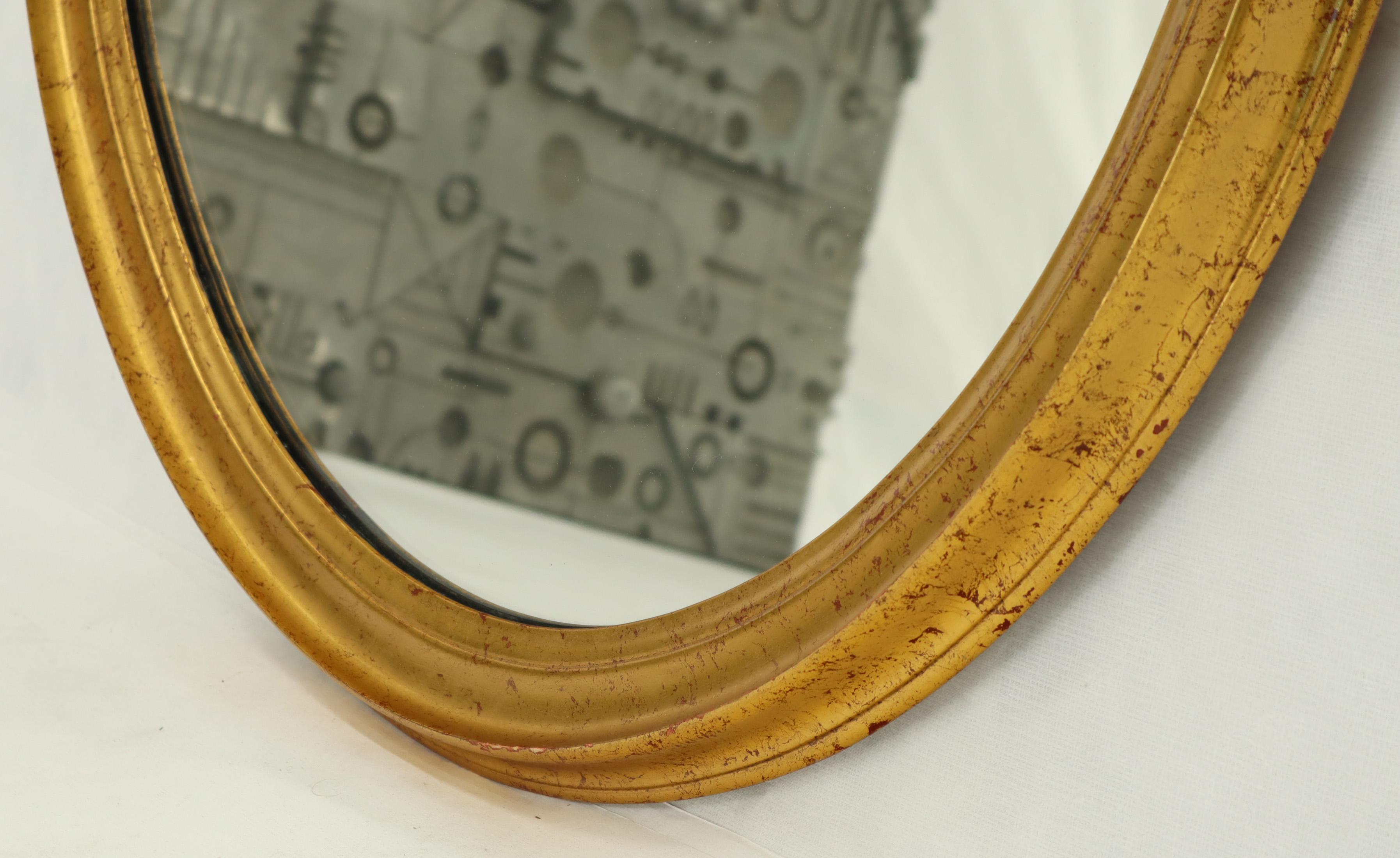 oval gold framed mirror