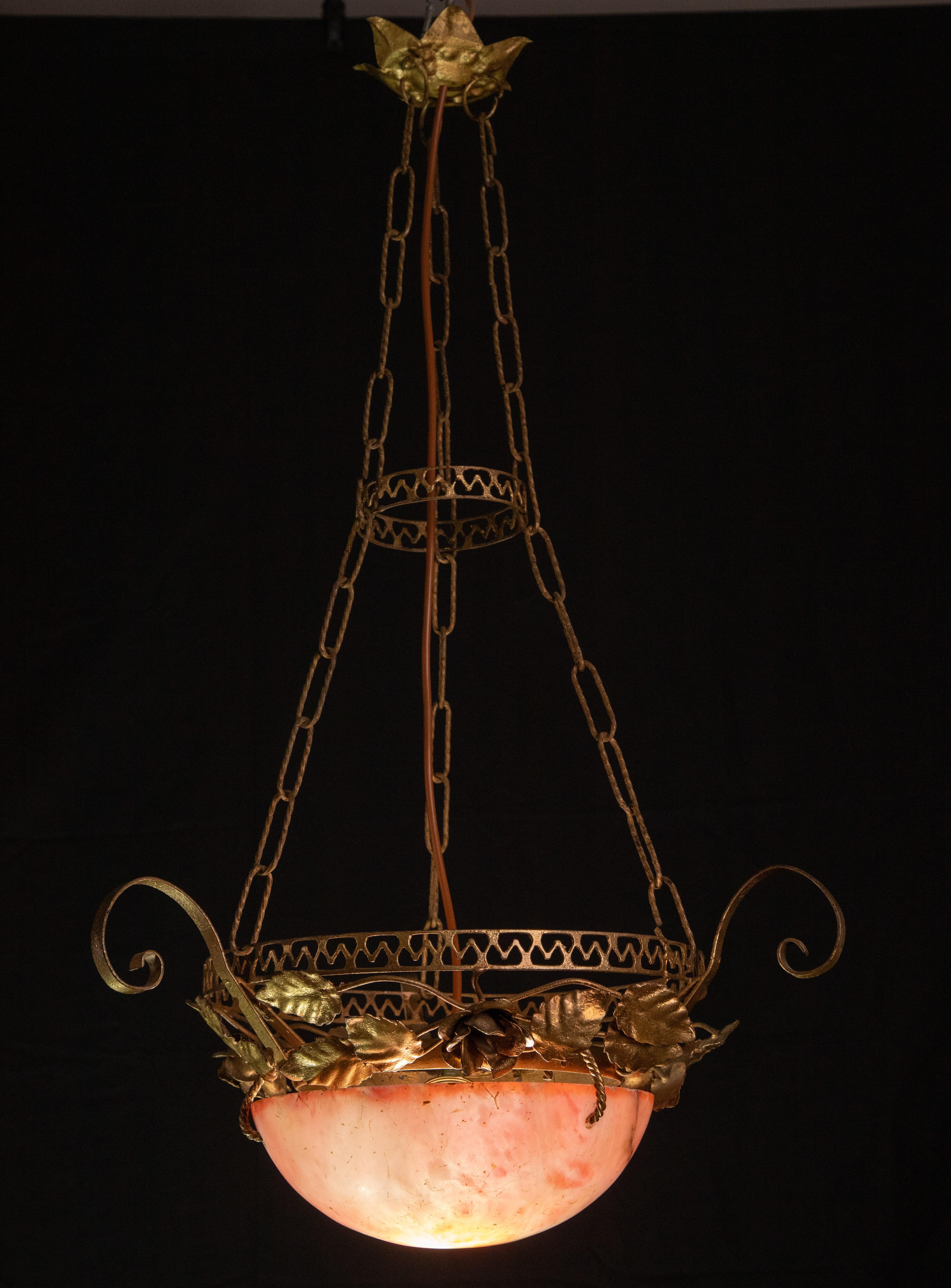 Extraordinary Antique red alabaster hanging chandelier with iron structure, perfectly restored
circa 1910s, extremely rare.
A unique piece in red alabaster, beautifully worked with shades and reflections of other colors when lit, still suspended