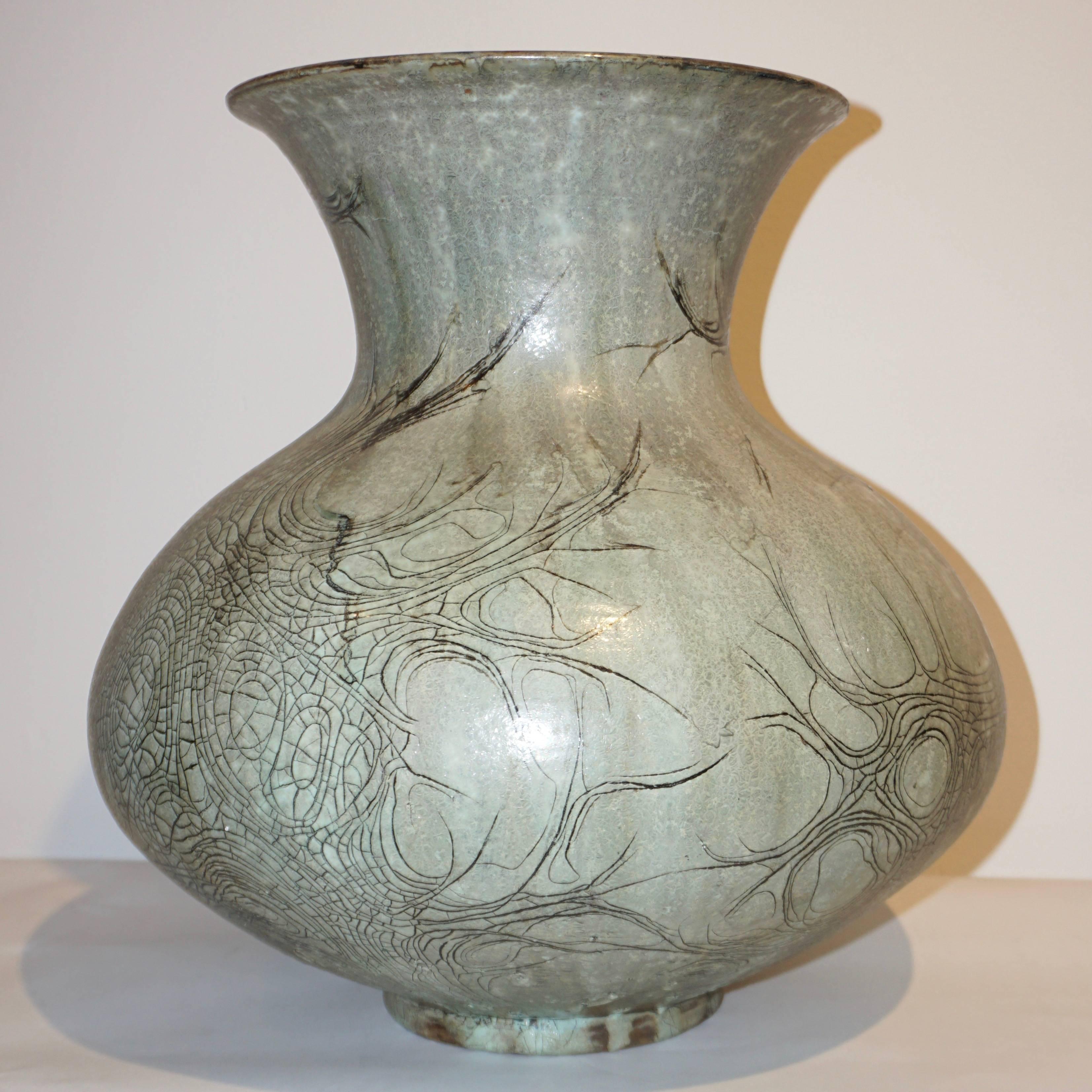 A large Mid-Century Modern organic ceramic vase, signed, created in La Borne (La Loire Valley) France, in grès stoneware skilfully enameled in a pebble gray tint and decorated with a hand carved drawing resembling ancient graffiti. The perfect grey