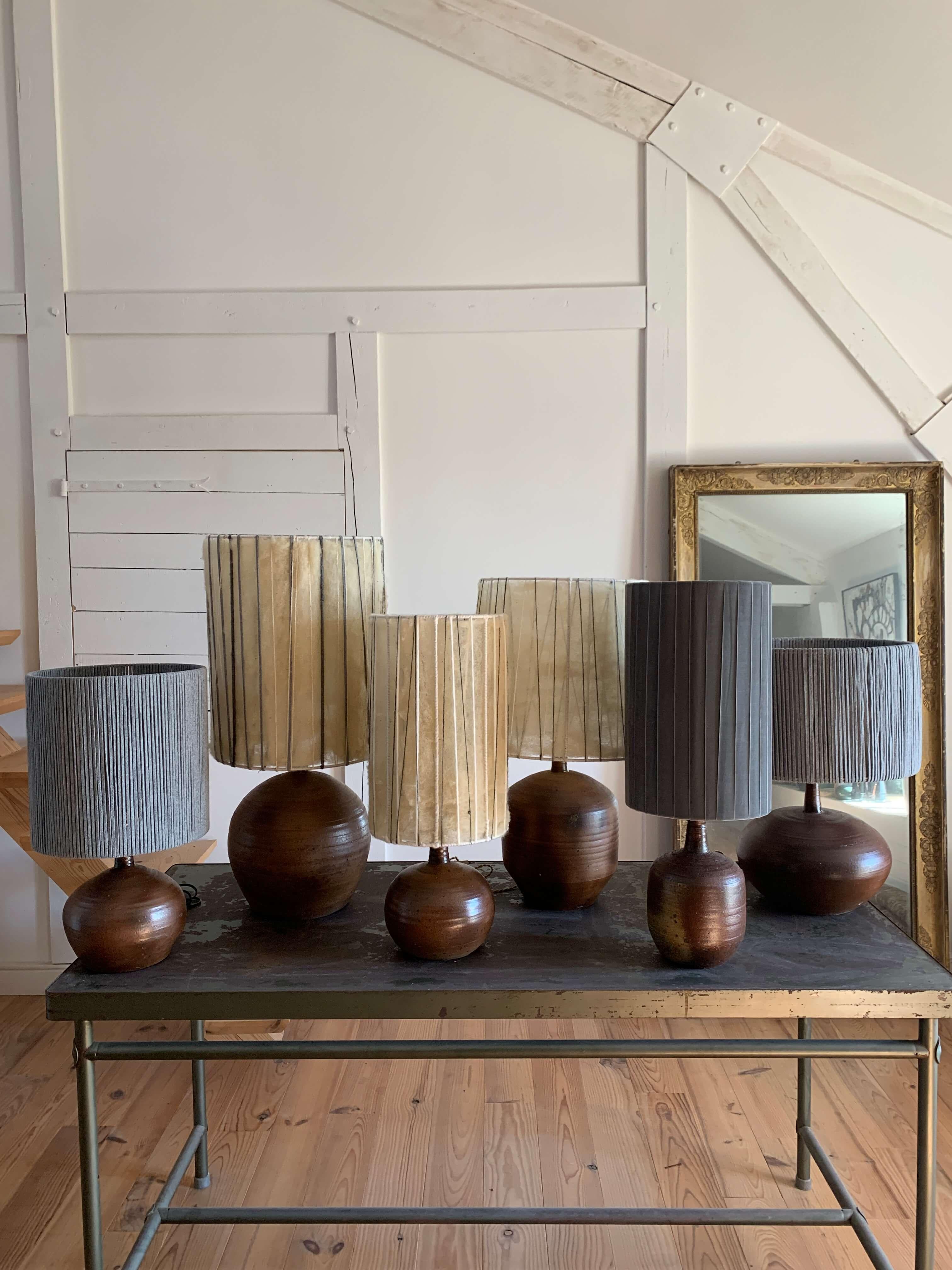 Janet Stedman (1945-1987) & Pierre Digan (1941-2016)

Renowned artists from the famous center of La Borne, France.
Set of six turned sandstone lamps, fired in a wood fire with an ash effect. Sold with custom-made lampshades created by a French