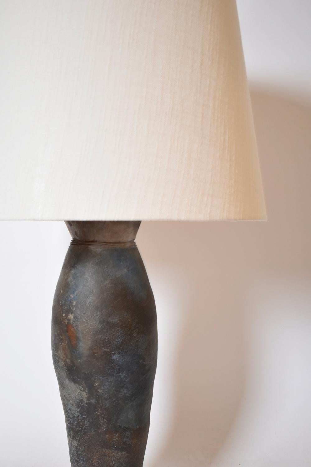 La Borne large stoneware oblong table lamp with hollow shell decoration, gray-blue background resting on a square base. France, 1970s.