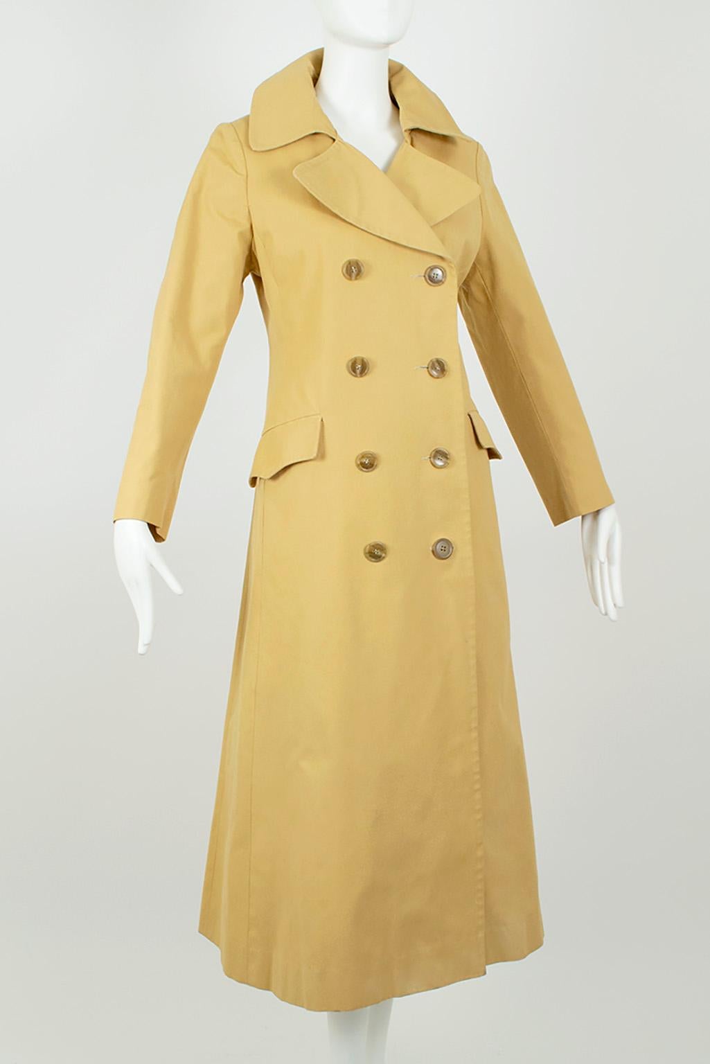 A true spy coat with drama to spare, this trench not only features a much longer, mid-calf length but also full length princess seams for a body sculpting silhouette. Its theatrical 6 ½’ skirt is offset by a close-fitting bodice for maximum movement