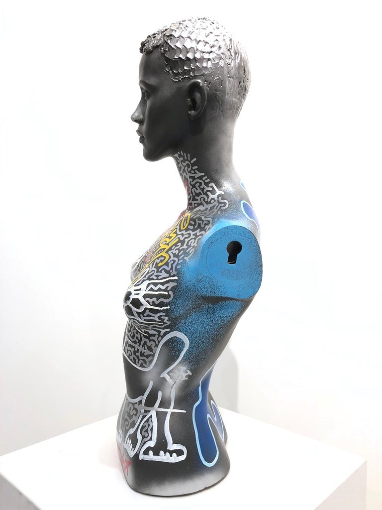 A beautiful street art, abstract Mannequin Bust decorated by artist Angel Ortiz. Here we find this stylish bust figure with the artist signature tag along with a figure of a cat, flowers, and calligraphy.

Sculpture measures 29.5 x 14.5 x 9.5