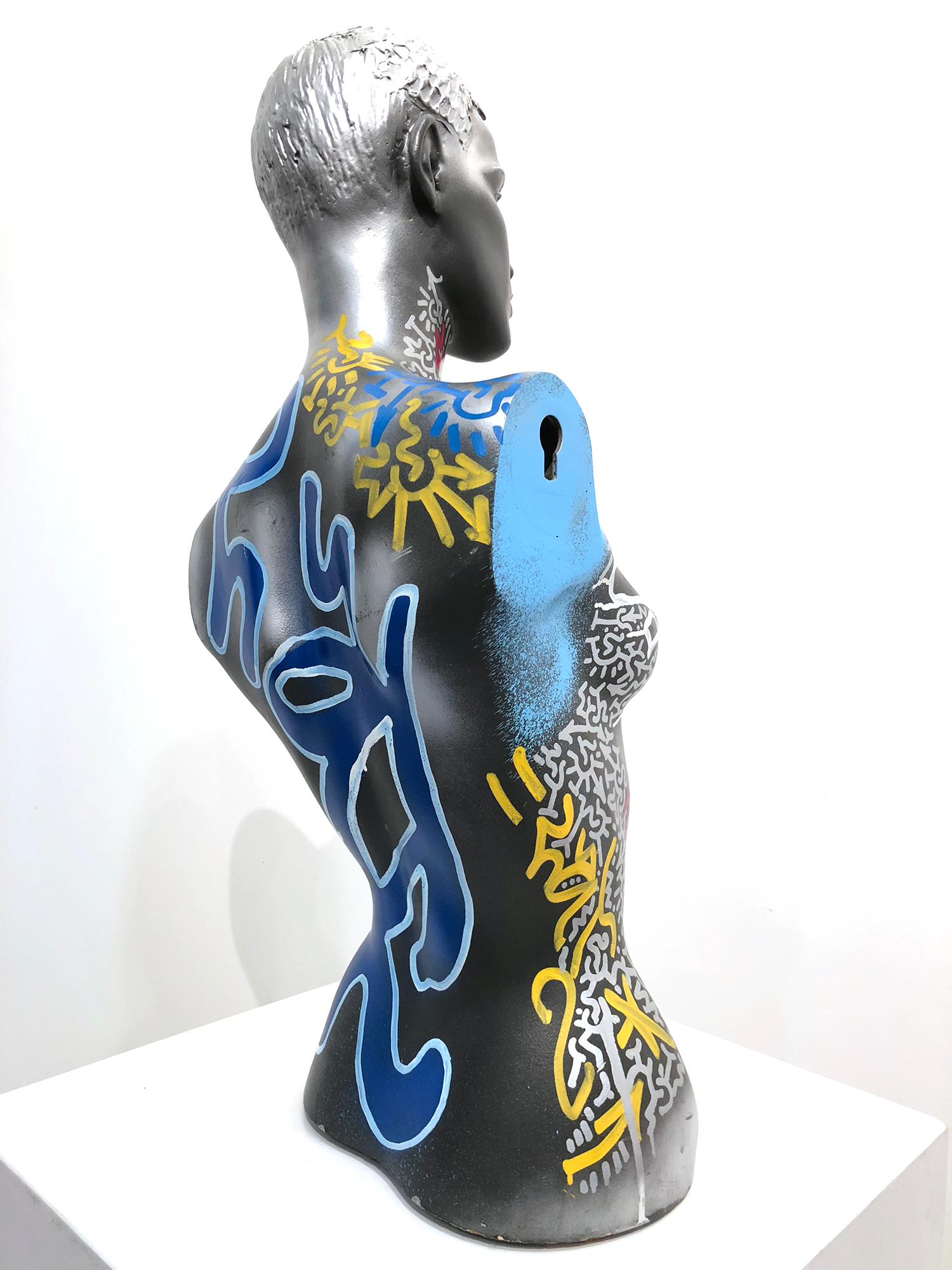 A beautiful street art, abstract Mannequin Bust decorated by artist Angel Ortiz. Here we find this stylish bust figure with the artist signature tag along with a figure of a cat, flowers, and calligraphy.

Sculpture measures 29.5 x 14.5 x 9.5
