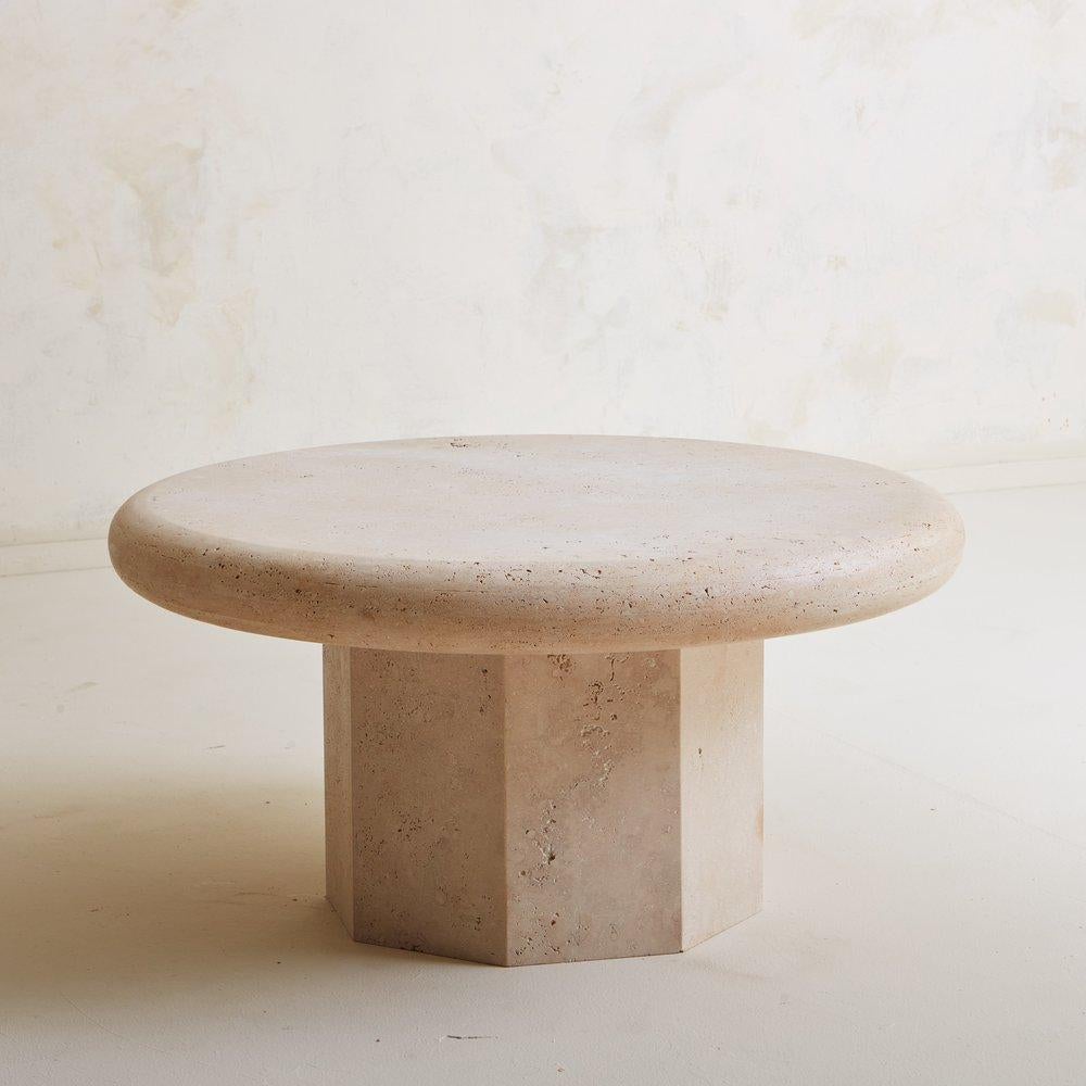 A custom coffee table designed in house by South Loop Loft. The “La Luna” table features a 3” thick unfilled travertine table top which rests on a mitered octagonal base. Our vision was to create something versatile and timeless that highlights a