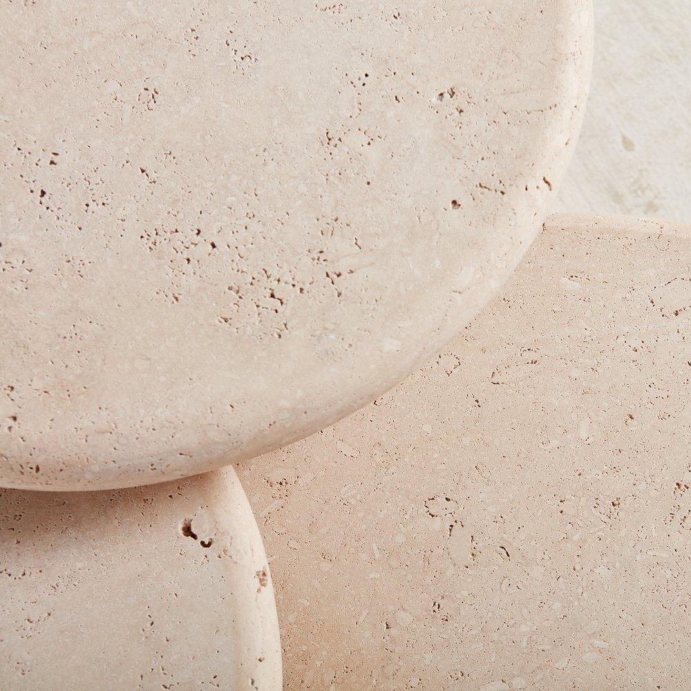 A custom set of coffee tables designed in house by South Loop Loft. The “La Luna” tables feature 3” thick unfilled travertine table top which rest on mitered octagonal bases. Our vision was to create something versatile and timeless that highlights