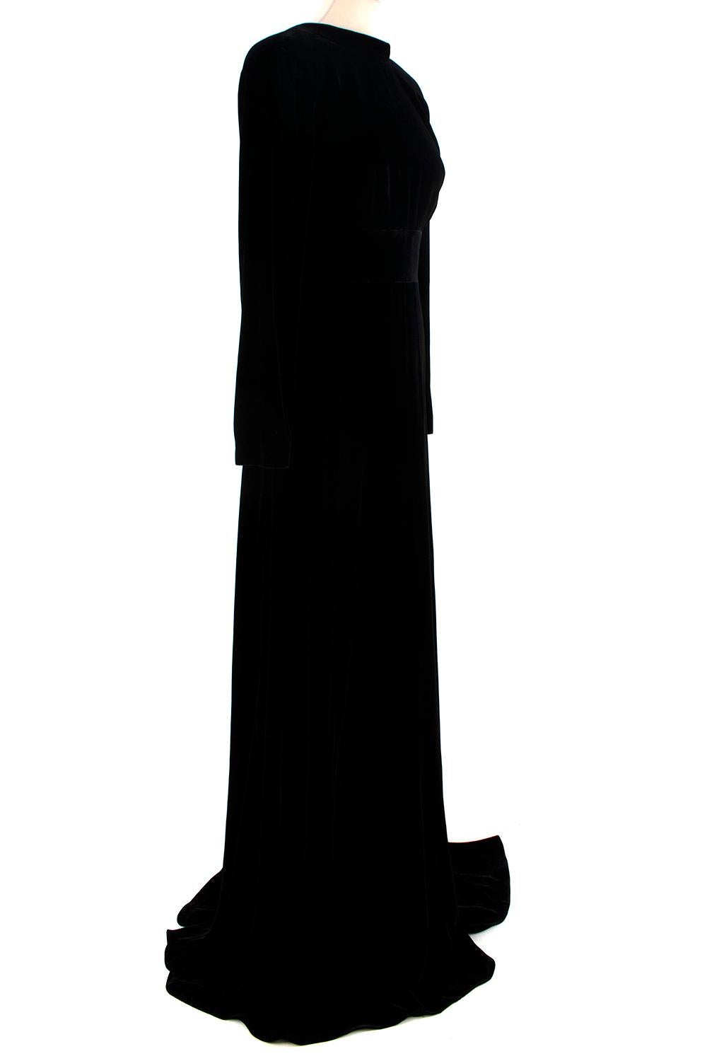 La Mania Black Velvet Low Back Gown 

- Stunning inky black velvet gown, with a sumptuous plush handle and incredible drape on the body
- A high mock neck, and simply cut bodice, giving way into a defined waist and flowing floor-length skirt with