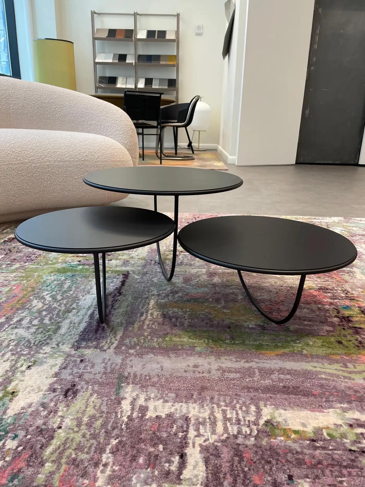 At first sight, Trio is a side table that consists of three transparent bowls overlapping one another. The opening of each bowl is covered with either a glass, metal or wood top. The shape of the bowl is suggested by a single curved line — seemingly