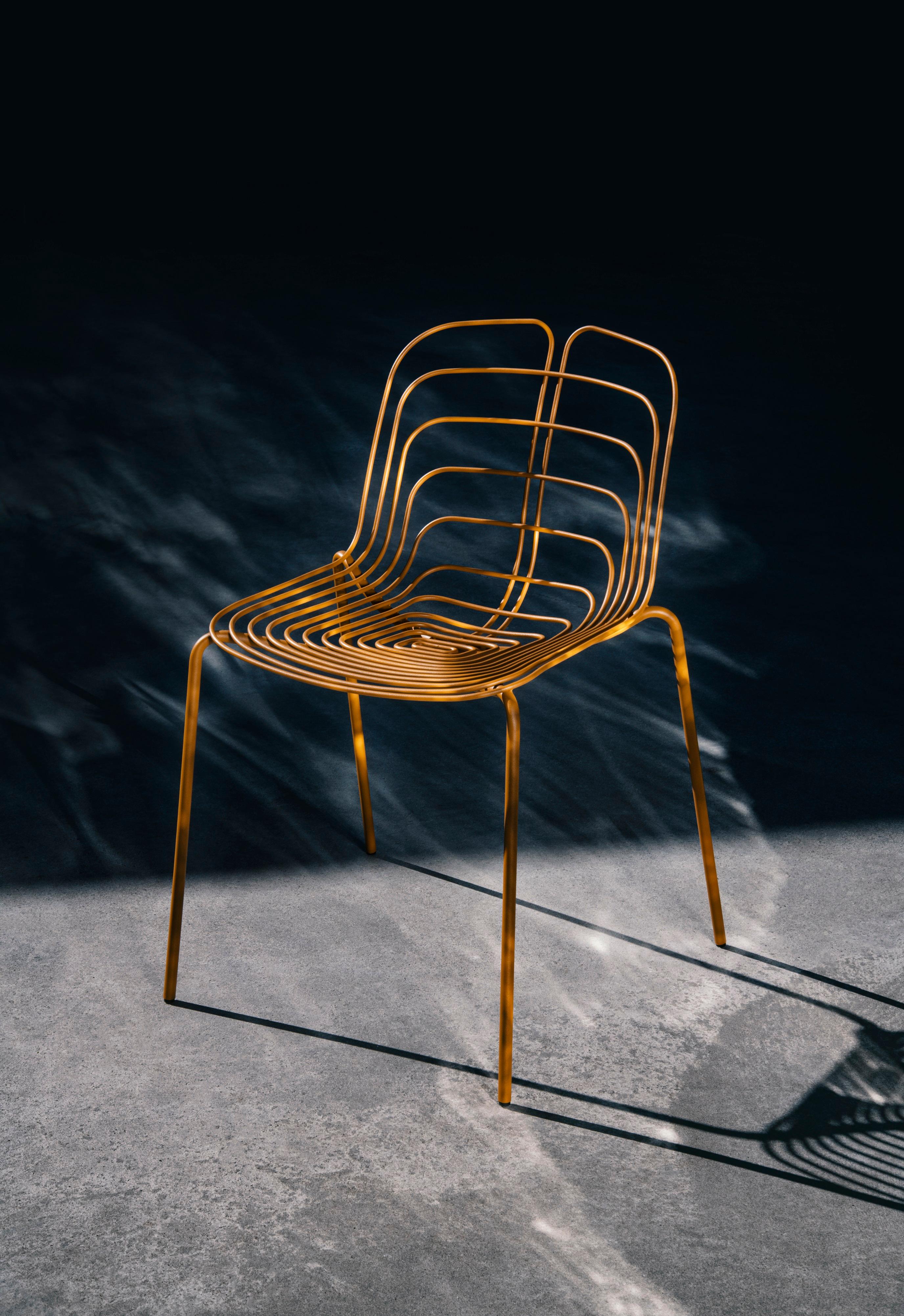 Stackable - up to 3
Different bases and finishes available.
The Wired Chair by Michael Young is a proud tribute to Harry Bertoia’s iconic design. This updated take on a classic piece is crafted from the same industrial material — steel wire, but