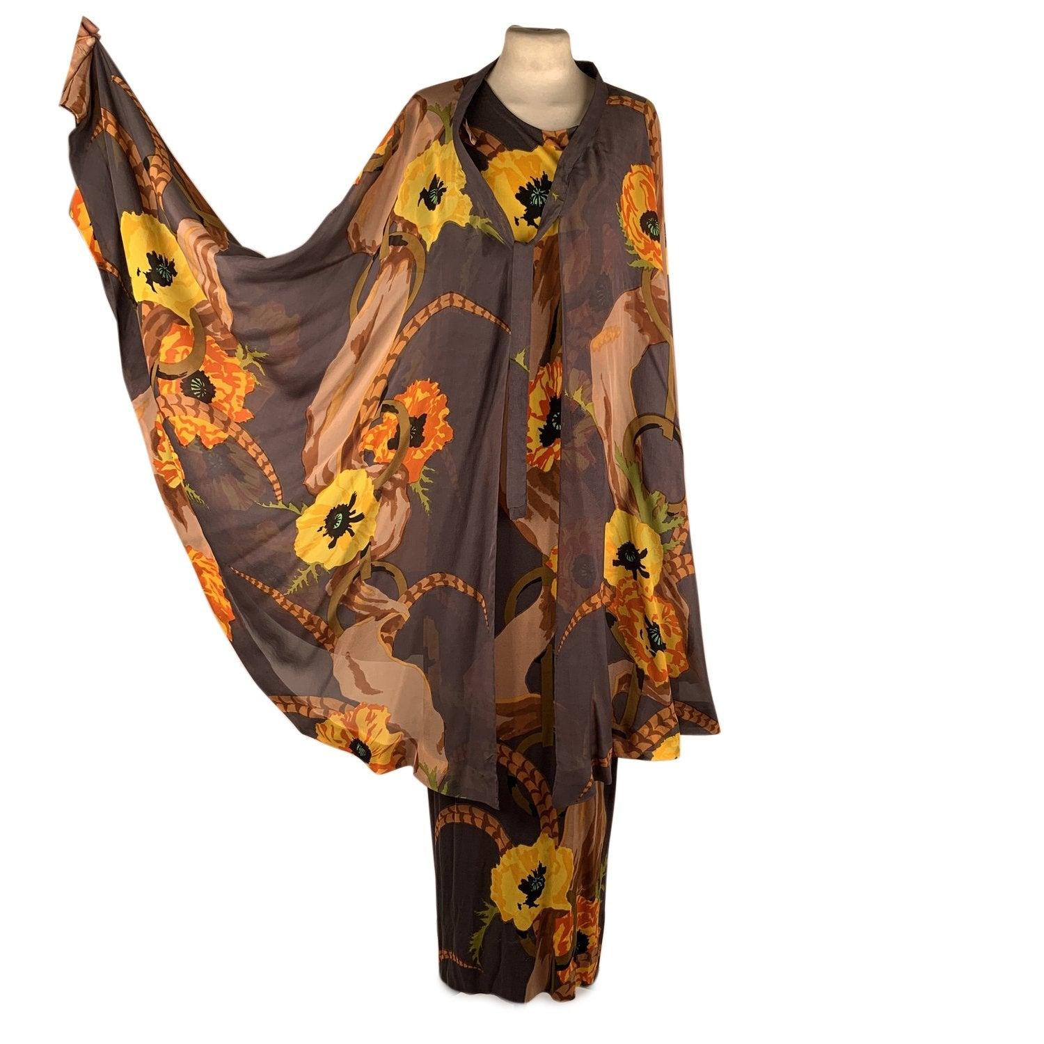 Description Vintage 1970 jersey and silk set of 3 pieces in a floral pattern from La Mendola, Italy consisting of a maxi dress, a belt and a matching semi sheer silk over skirt. Beautiful Gray, Brown,Yellow, and Orange colors. The dress has short