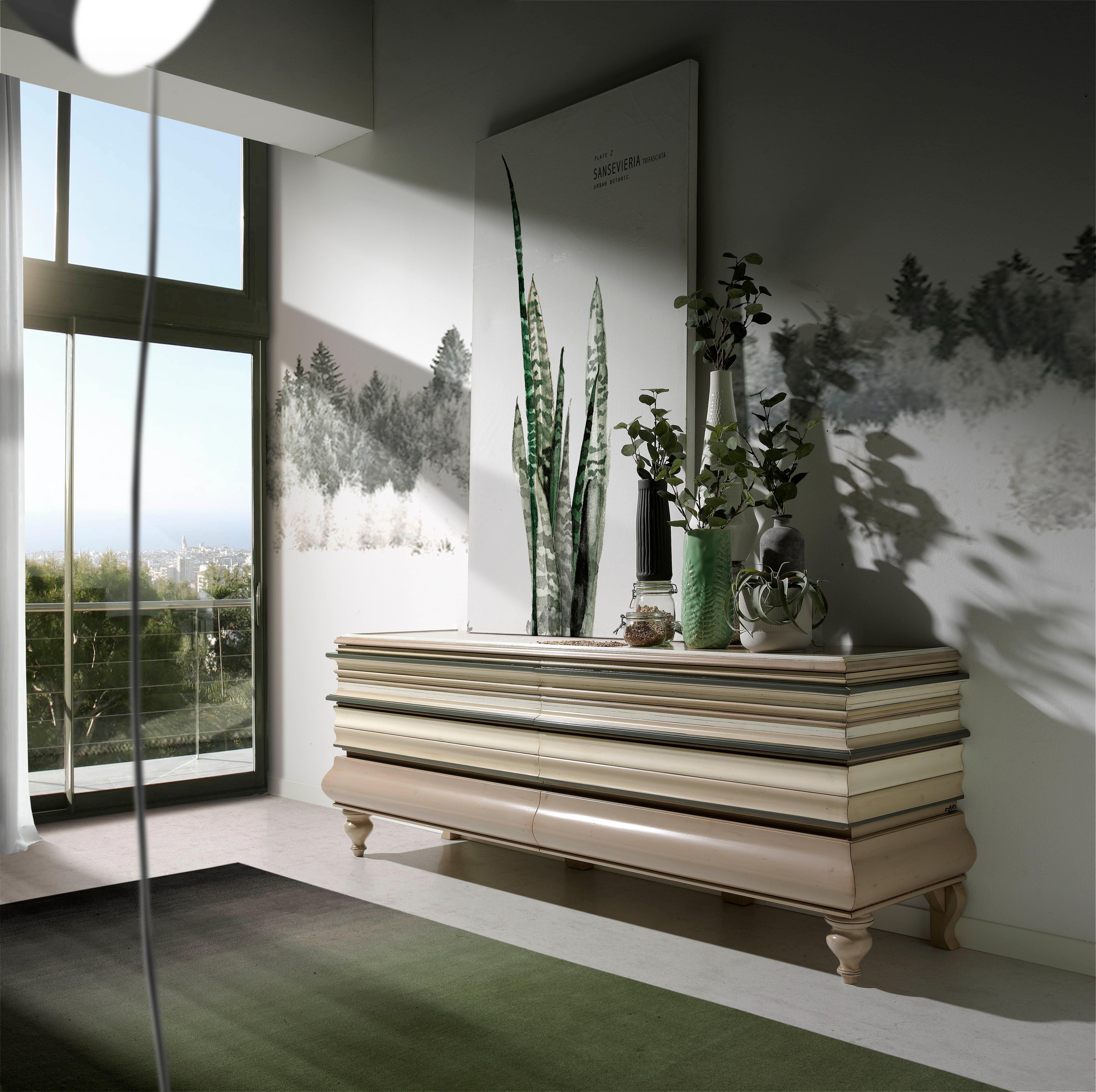 Buffet La Mèr, deux portes et deux tiroirs, par Lola Glamour
Dimensions : D 52 x L 185 x H 70 cm
MATERIAL : Bois.

Comme les rimes enchaînées d'un long poème, les moulures horizontales entourent la série La Mèr de leur cadence opulente. Ils