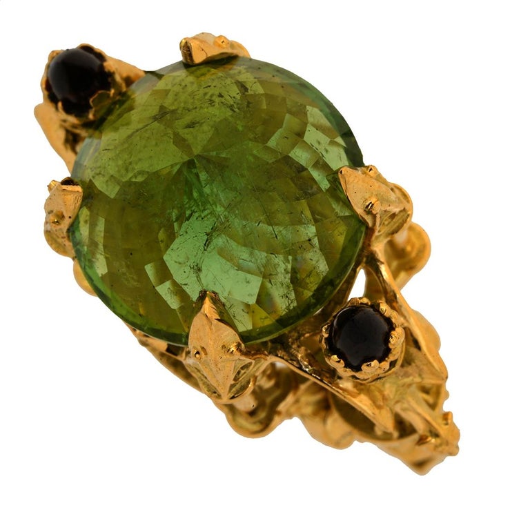 LA MUSE VERTE RING

This enchanting ring is a truly marvellous one of a kind piece.

Exquisitely handcrafted in 18kt yellow gold this intricate ring features a stunning green round checkerboard cut tourmaline resplendent atop a signature William
