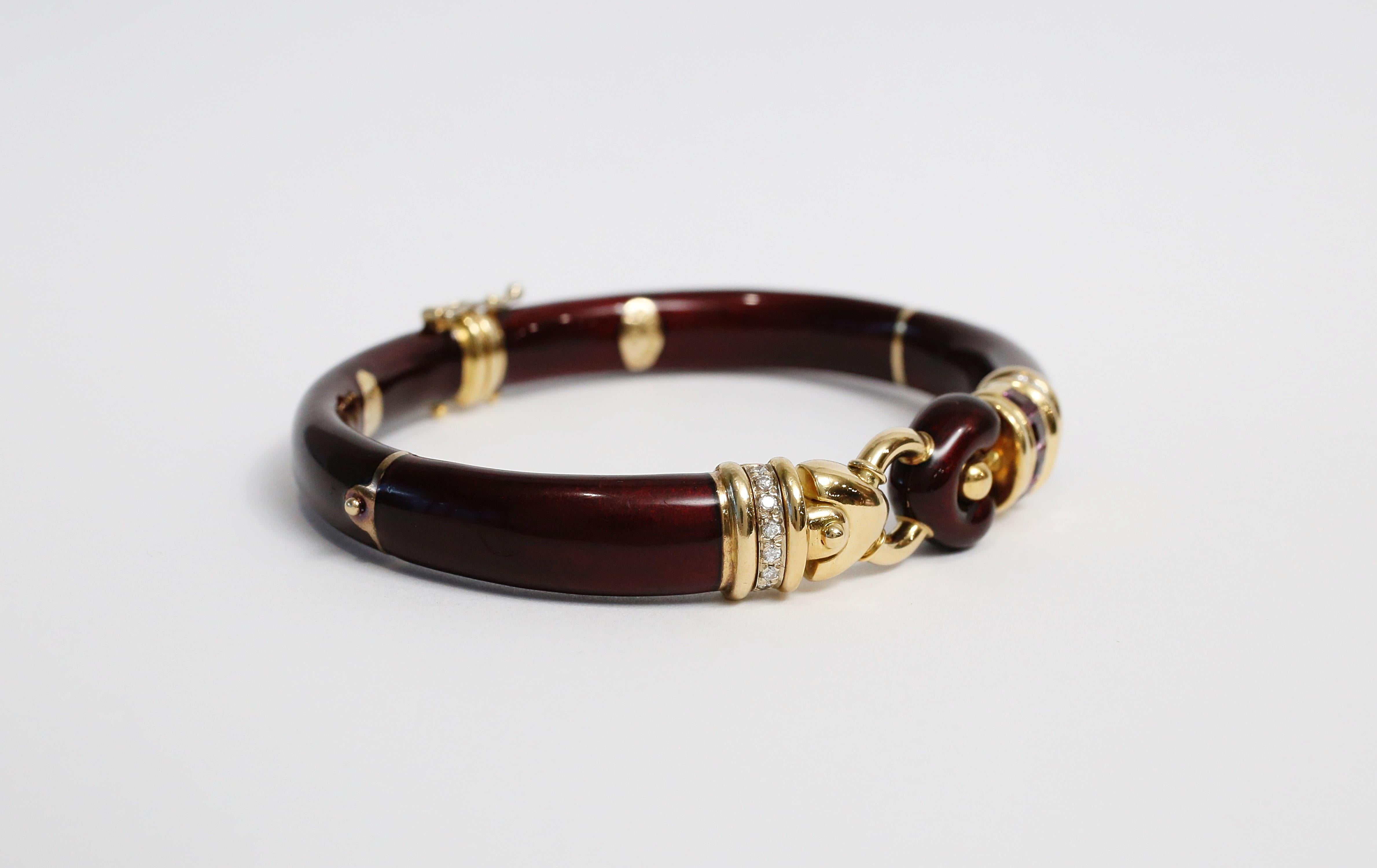 This gorgeous bangle by La Nouvelle Bague of Florence Italy is crafted with accents of 18k yellow gold and a beautiful deep burgundy enamel surface on top of sterling silver. The bangle bracelet has a hinge opening and a box clasp closure. The