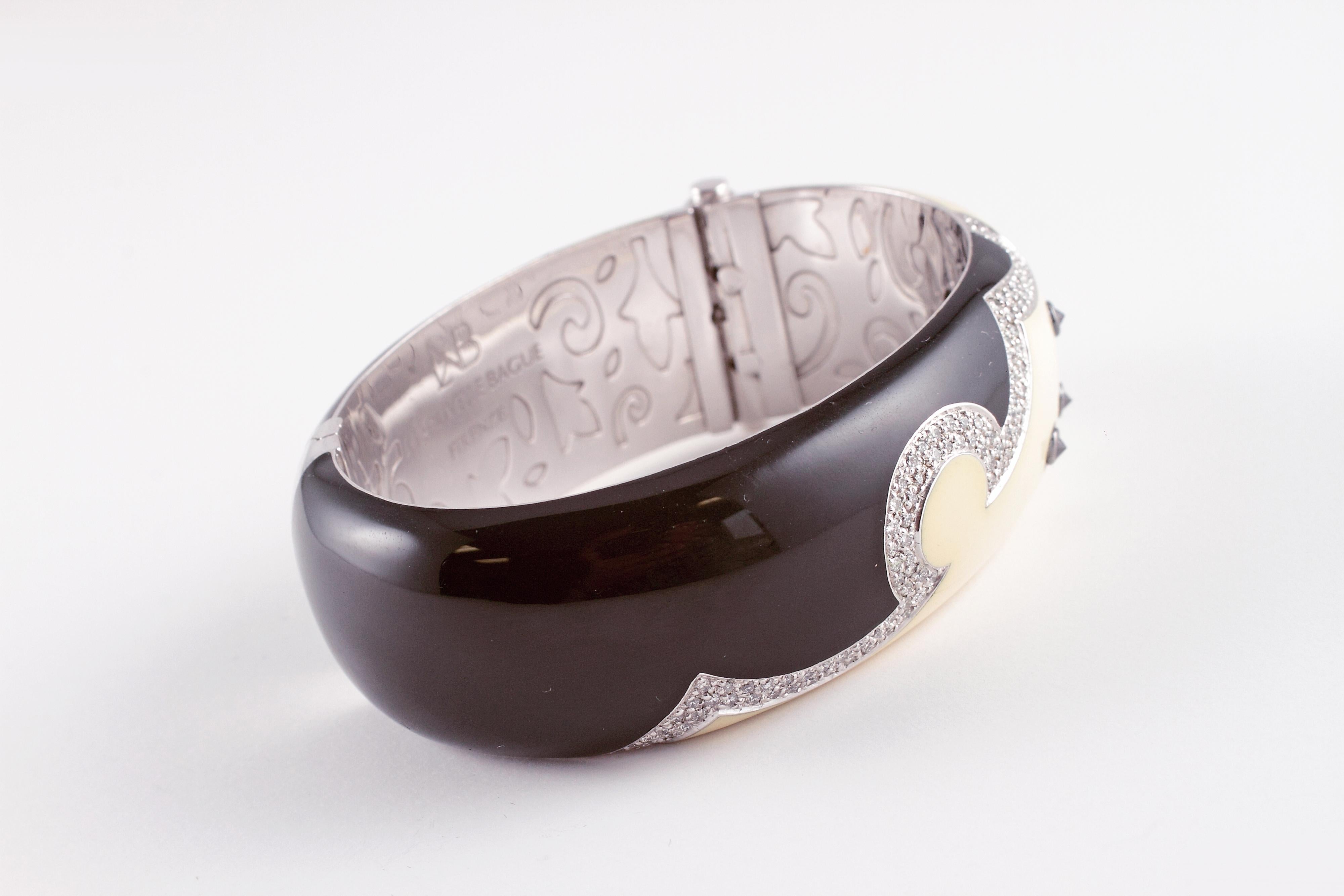 Such a fun piece!  This bracelet by la Nouvelle Bague  and is composed of 18 karat white gold, black and cream enamel and features approximately 100 round diamonds, stated to be VS 1 - VS 2 in clarity and G - H in color with a stated total weight of
