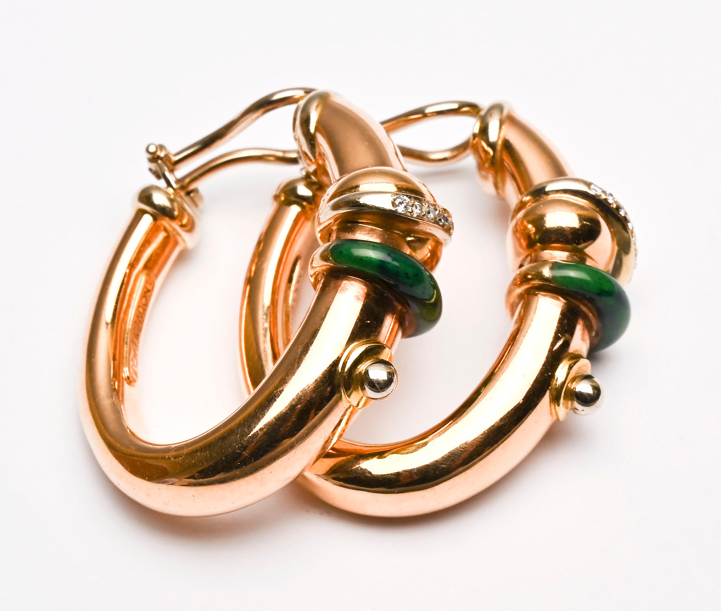 Sporty and sophisticated oval hoop earrings by La Nouvelle Bague.  A band of green enamel encircles the hoop with another diagonal band of pave diamonds. above it. Clip backs can be converted to posts.
The earrings are 1 7/16