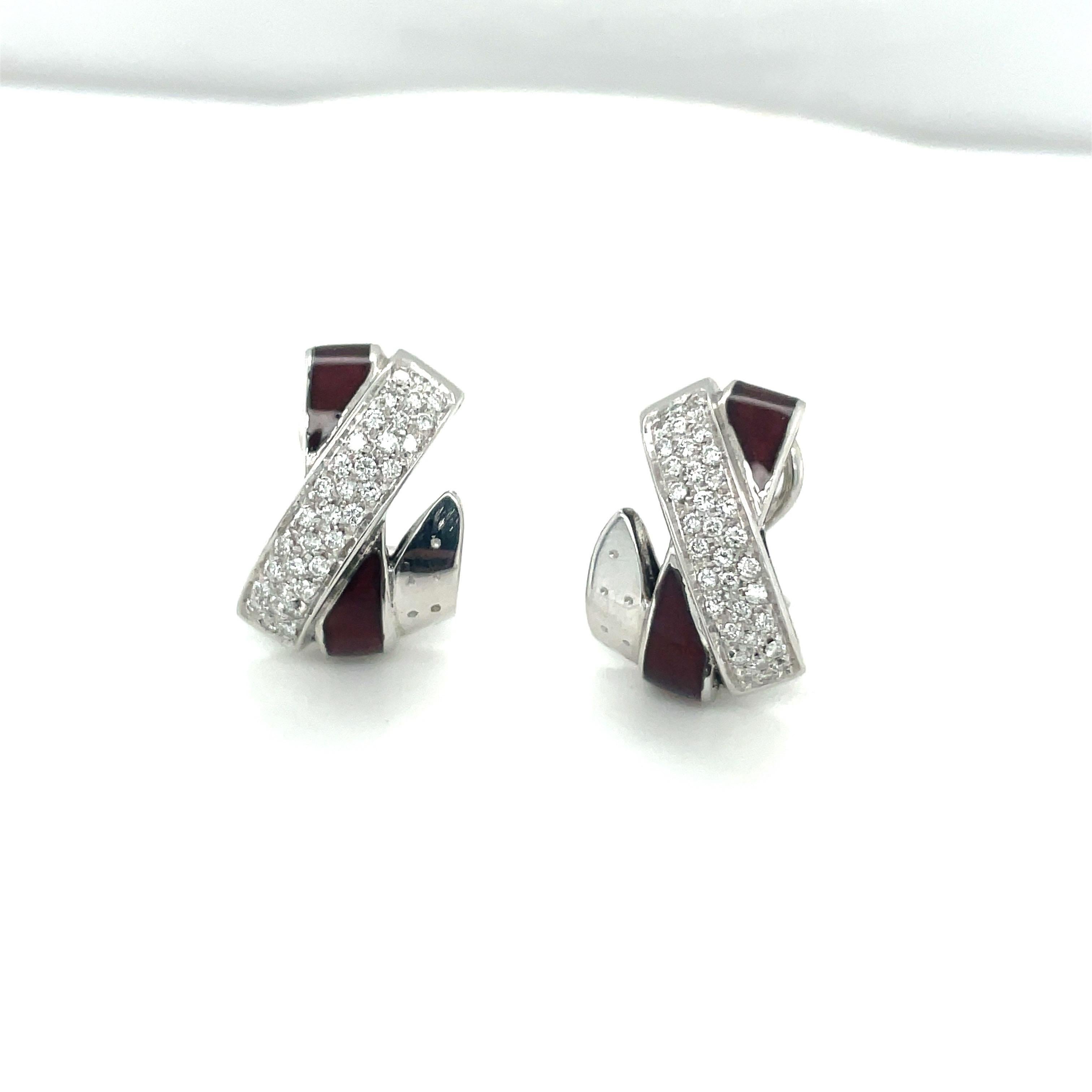 These beautiful 18kt white gold La Nouvelle Bagues  earrings ,done in their signature criss-cross motif are accentuated by pave diamonds and burgundy enamel. They measure 21 mm in length. They have post /omega  backs. They can be adjusted for non