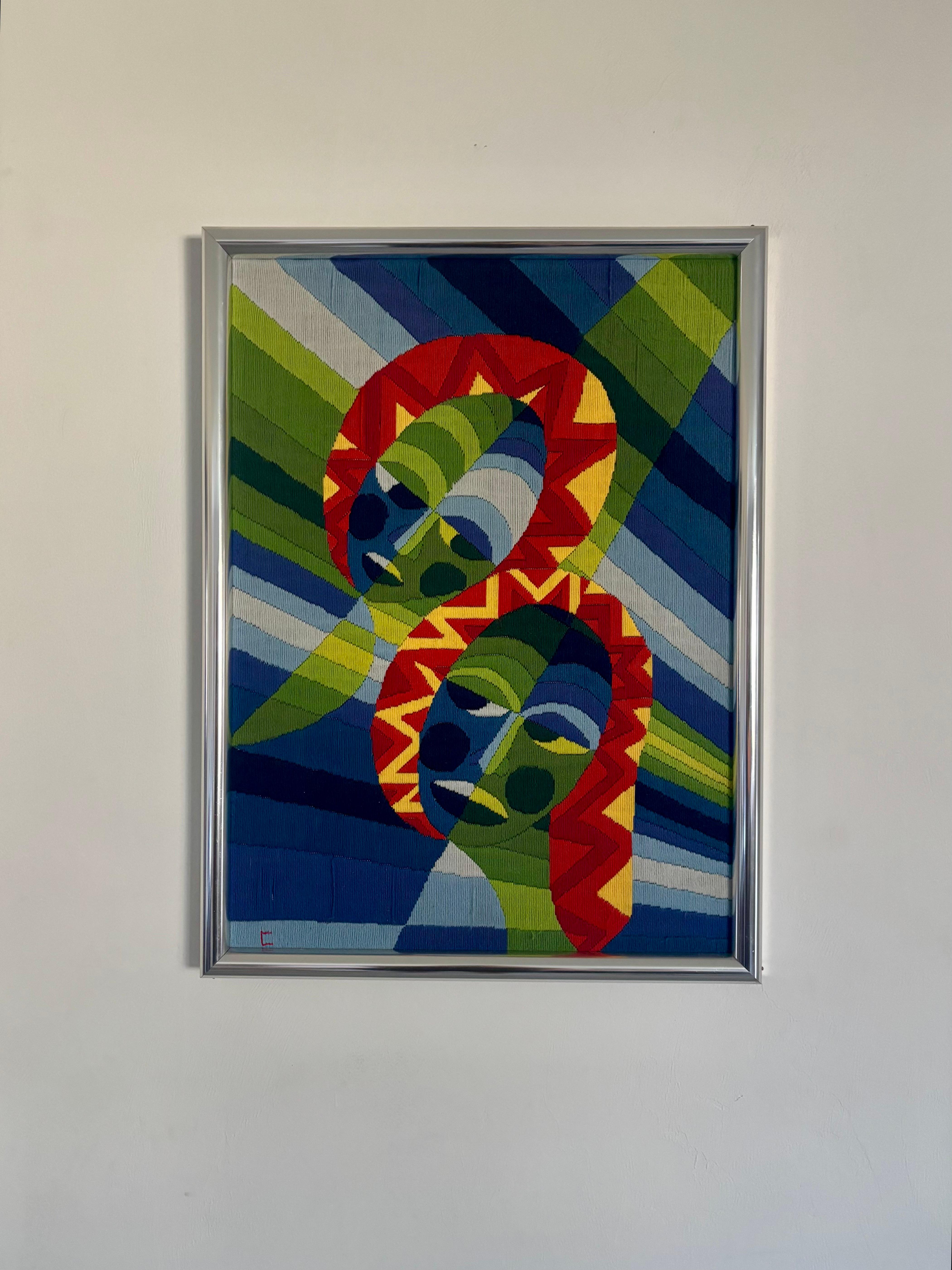 Stunning and vibrant French mid century modern geometric tapestry. Hand embroidered in the 1960s. Based off art by O. Penhouet titled “Les Amours Partagées”. 

Framed in a chrome frame and ready to hang in your home. 

Dimensions are 
30” tall
22”