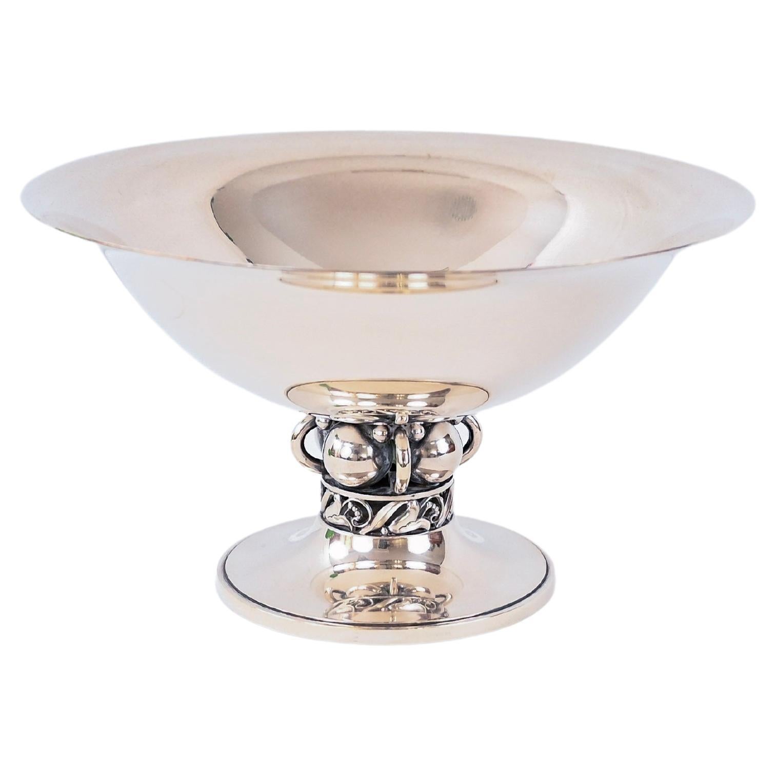 An impressive sterling silver bowl by Alphonse La Paglia for International Sterling. Alphonse La Paglia is known for his distinct designs and studied under Georg Jensen. This bowl has loop and ball detail on a footed bottom. It is numbered and