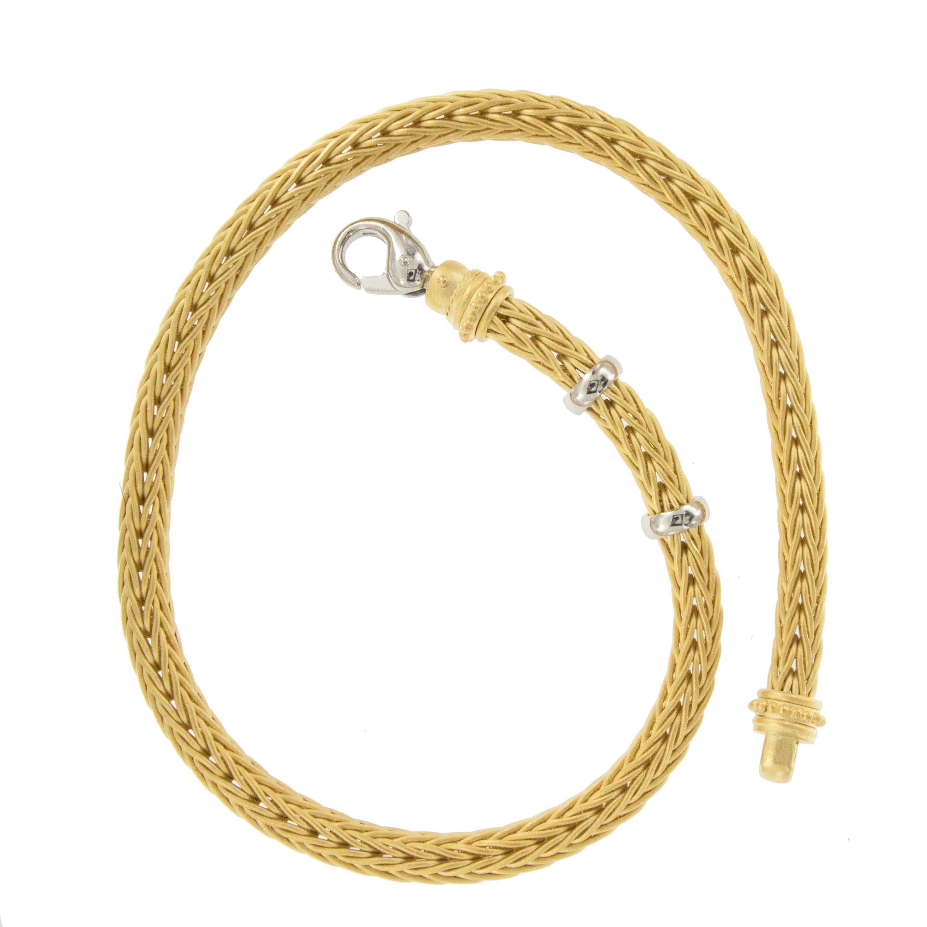 Rarely seen, this fabulous, heavy 18 karat yellow gold necklace is beautifully hand-fabricated (woven) in a wheat weave pattern. It is adorned with finials ornamented with granulation and Platinum accents.   A spectacular example of goldsmith's art,
