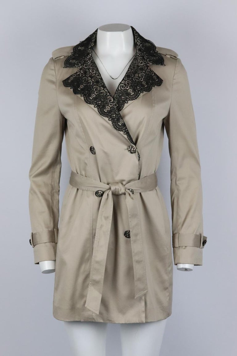 La Perla belted double breasted satin trench coat. Beige and black. Long sleeve, v-neck. Button and belt fastening at front. 73% Cotton, 24% viscose, 3% elastane; insert: 100% cotton; lining: 68% acetate, 32% polybutylene. Size: IT 42 (UK 10, US 6,