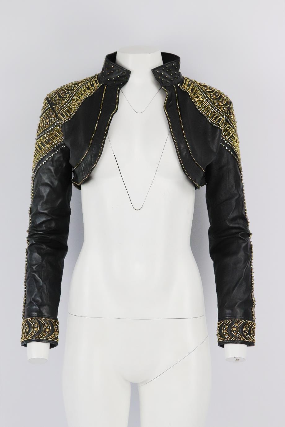 La Perla cropped embellished leather jacket. Black and gold. Long sleeve, v-neck. Slips on. 100% Lambs leather; lining: 100% polyester. Size: IT 44 (UK 12, US 8, FR 40). Shoulder to shoulder: 17 in. Bust: 36 in. Length: 10.75 in
