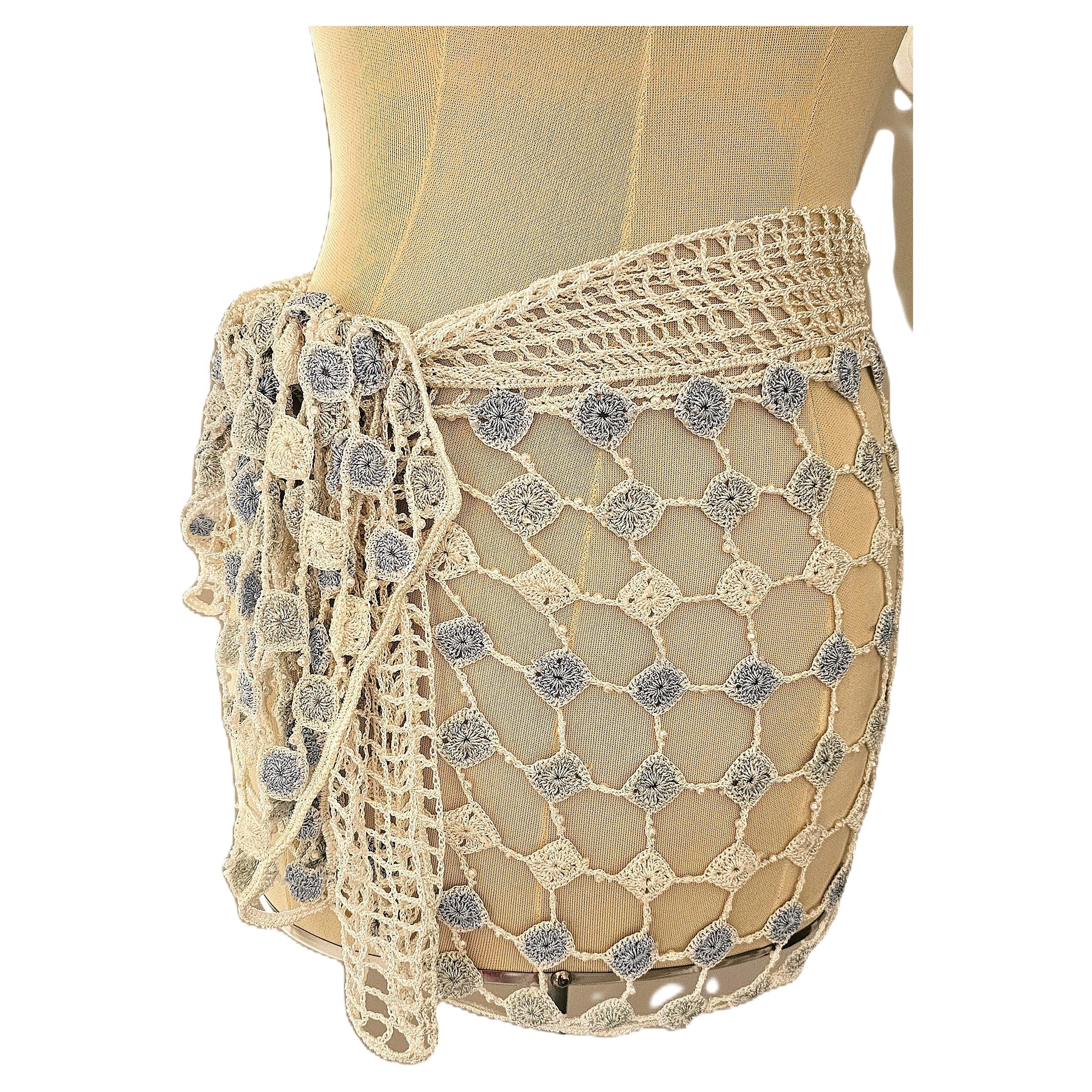 The La Perla Oceano crochet Beach Cover Up from the 1990s are exquisite examples of the brand's commitment to luxury and craftsmanship. These pieces feature intricate crochet work adorned with delicate beads, embodying the bohemian elegance that was