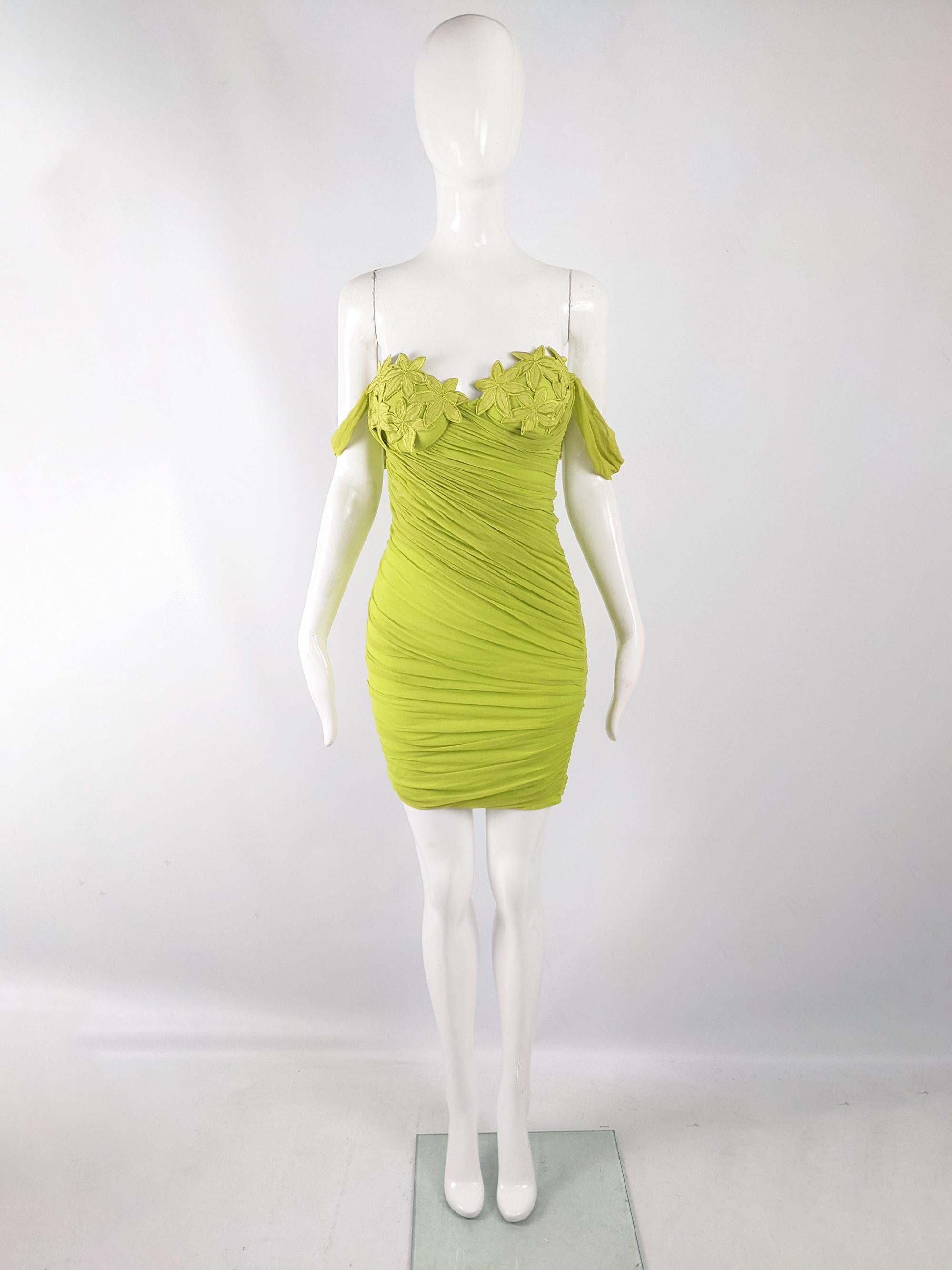 An incredible and sexy vintage womens party dress from the late 80s / early 90s by luxury Italian fashion house, La Perla for their Ritmo di Perla line. In a lime/ acid green stretch mesh over a clingy, body conscious jersey. It has ruching at the