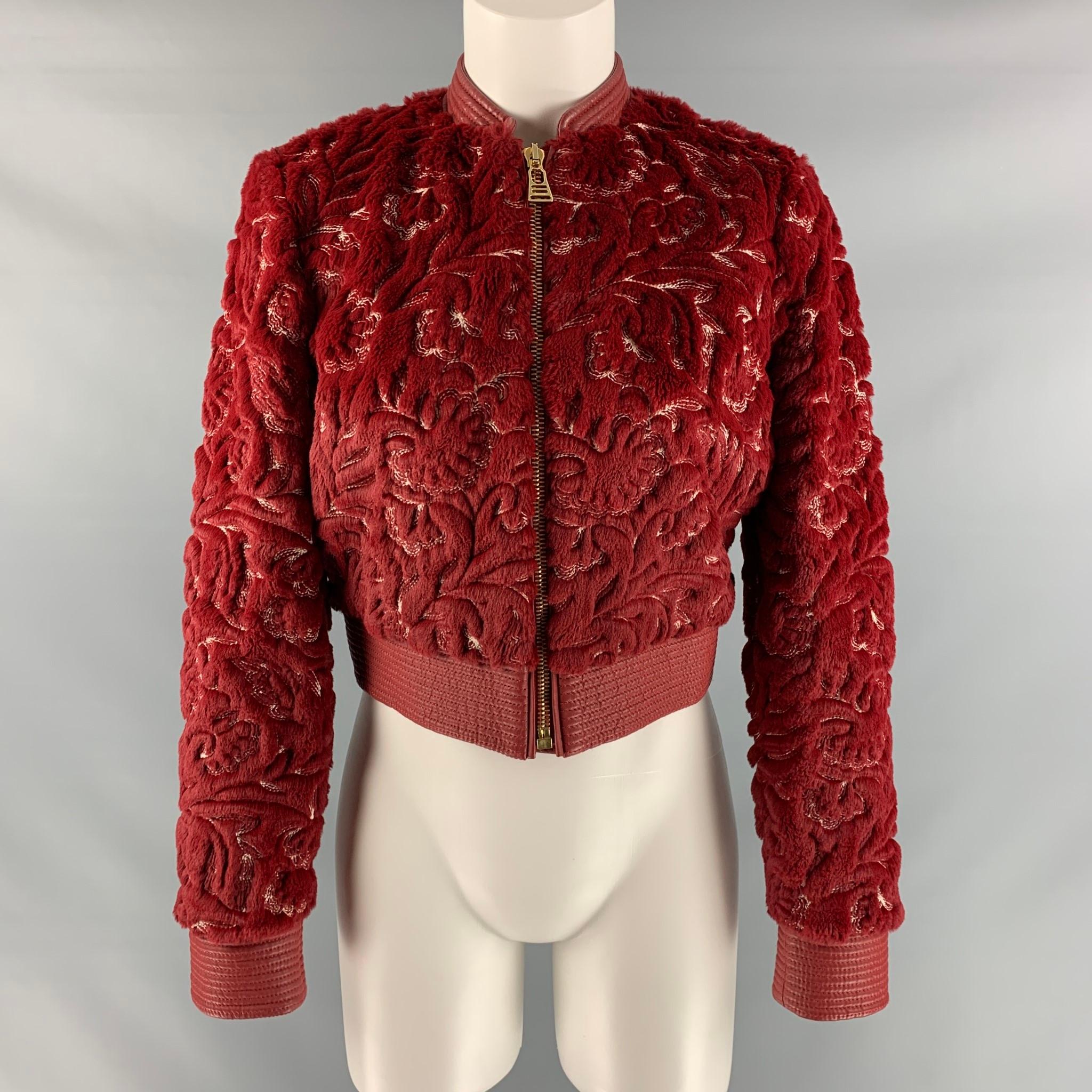 LA PERLA jacket comes in a red and white faux fur polyester and cotton with a full liner featuring a bomber style, leather trim, embroidered details throughout, slit pockets, and a gold toe zip up closure. Made in Italy.

Excellent Pre- Owned