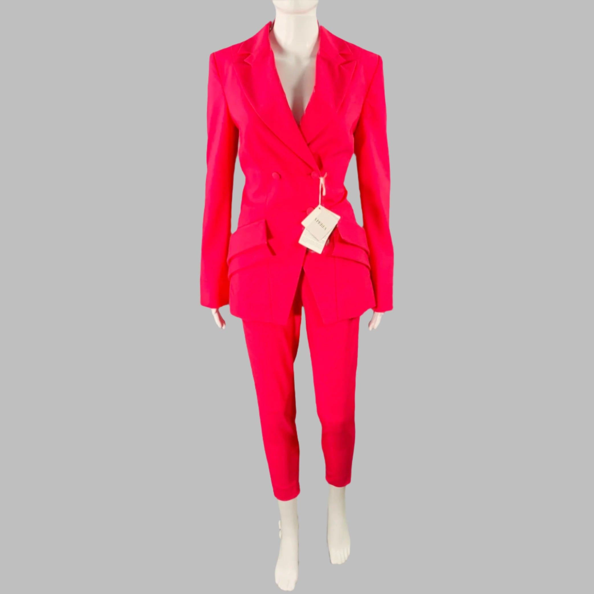 LA PERLA pantsuit in a pink wool stretch blend fabric which includes a peak lapel, layer detail pockets, buttoned closure jacket and matching flat front pants with ankle zip details.Very Good Pre-Owned Condition with Tags. Minor signs of wear.