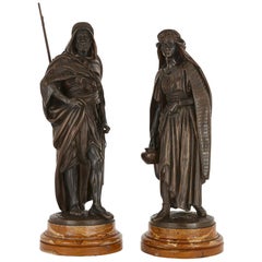 Antique ‘La Porteuse’ and ‘Le Guerrier Arabe’, Two Patinated Bronze Figures by Salmson