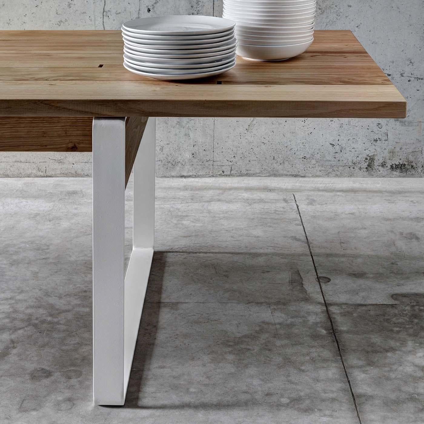 A stunning table that combines the natural elegance of wood and the sleekness of steel, this piece will have a great visual impact in a contemporary dining room or an industrial study. It was designed by Act_Romegialli with a top in chestnut, made