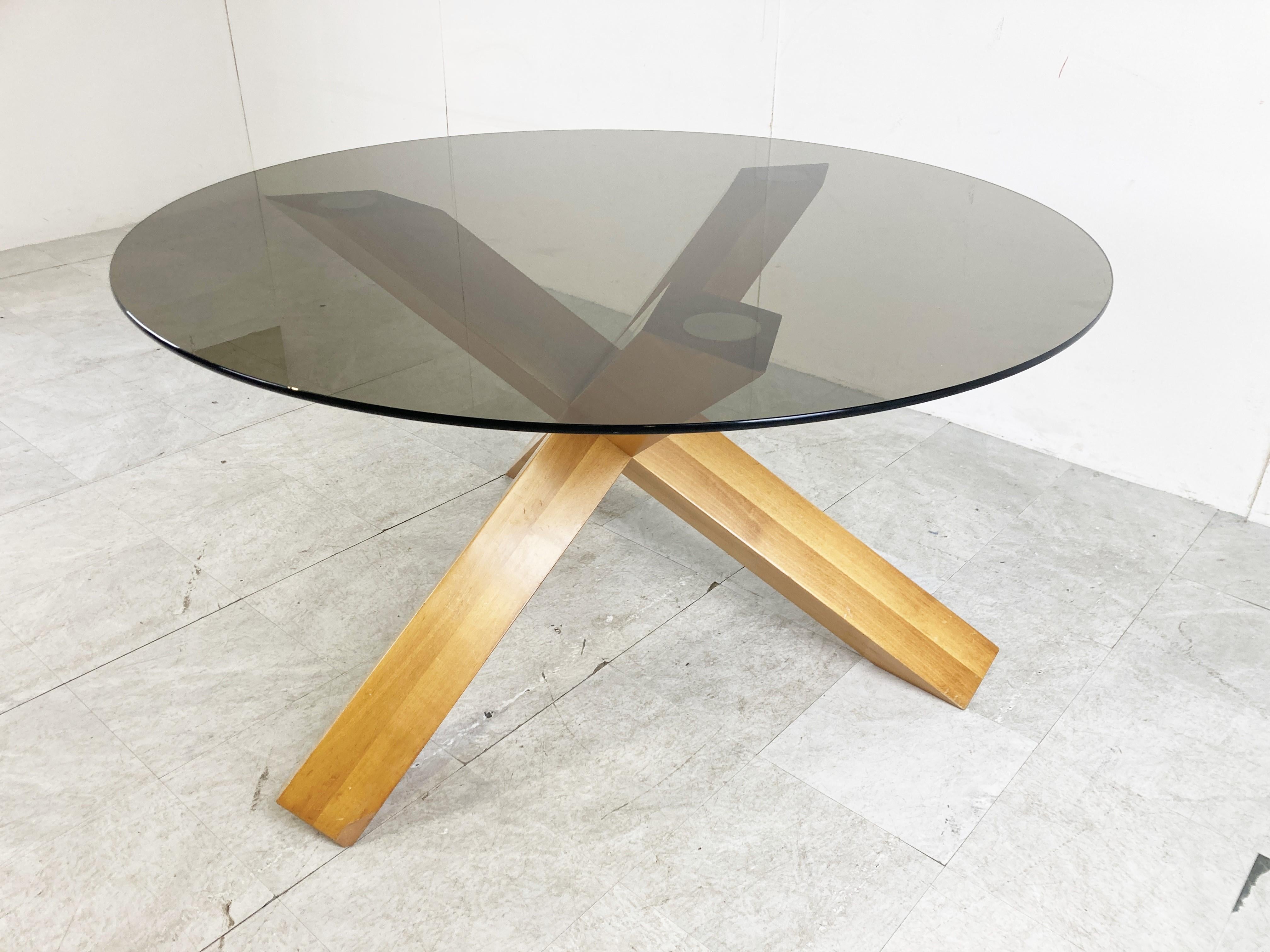 Midcentury ash wood dining table by Mario Bellini for Cassina.

The table has a striking tripod base made from solid ash wood and a smoked glass table top.

Design Classic and produced by Cassina, this is an early seventies production.