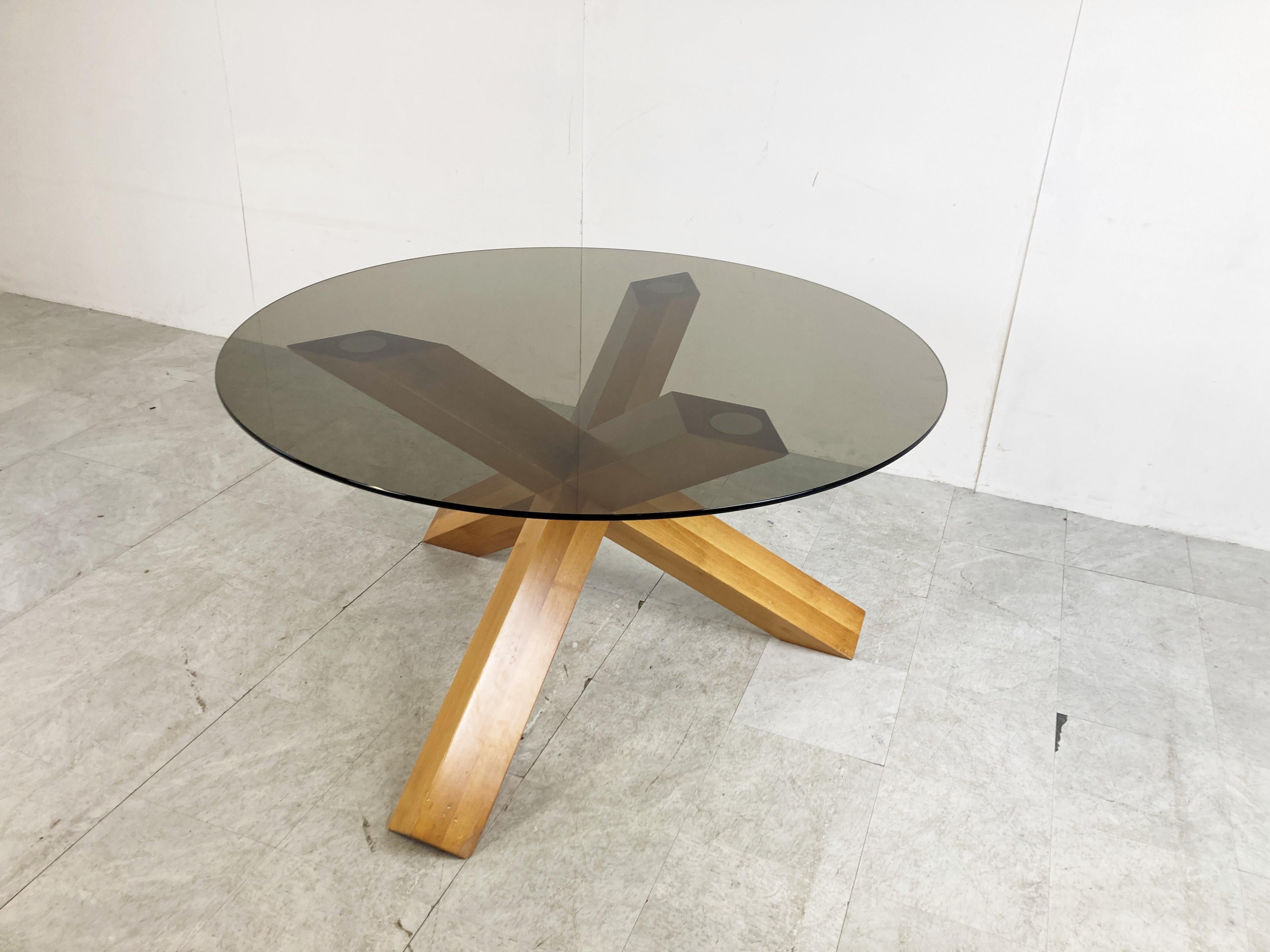 Midcentury ash wood dining table by Mario Bellini for Cassina.

The table has a striking tripod base made from solid ash wood and a smoked glass table top.

Design Classic and produced by Cassina, this is an early seventies production.
