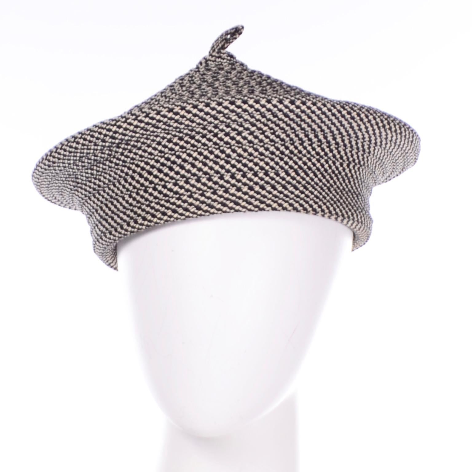 This incredible vintage hat was made by La Sartan, the French luxury hatmaker. This woven black and white beret style hat has a very unique and interesting shape. The beret has with a little more structure than the traditional fabric beret. This