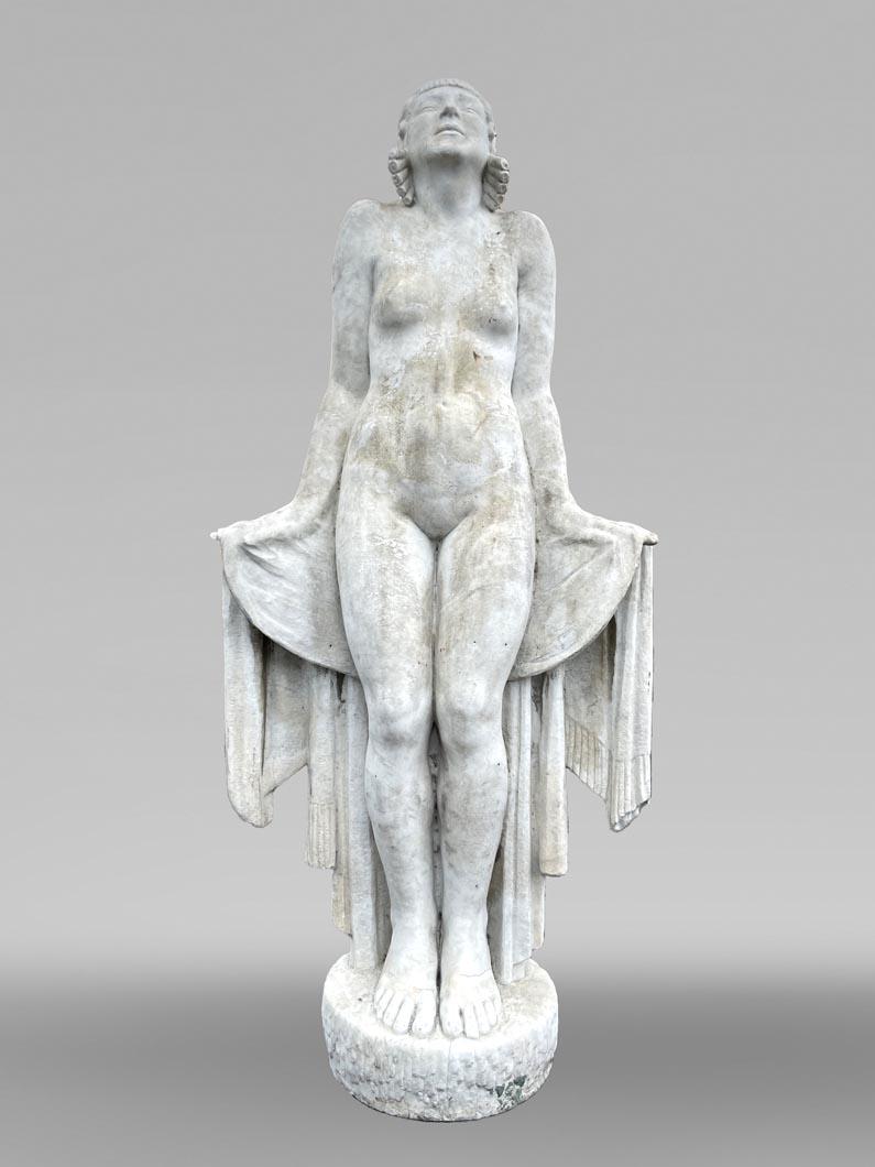 Graceful and slender, this monumental white marble sculpture perfectly embodies the elegance of 1930s Art Deco, in the style of the French sculptor Félix-Pascal Févola (1882–1953). Entitled La Sortie du bain (The Bath Exit), it depicts a young woman