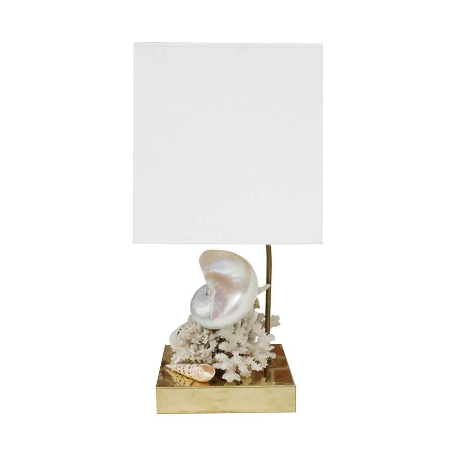 
These table lamps designed by L.A. Studio and manufactured in Italy exude a sophisticated charm. The lamps feature a sturdy brass structure adorned with natural corals and mother of pearl shells, adding a subtle touch of nature's beauty. The brass