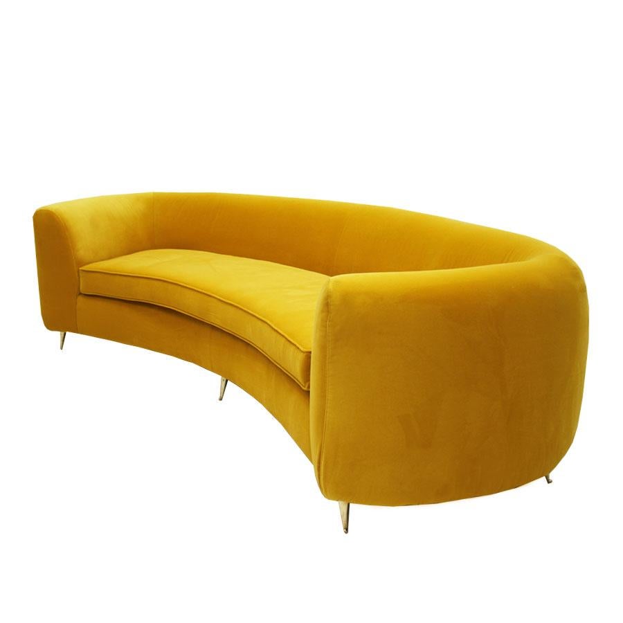 Curved sofa upholstered in yellow cotton velvet and legs made of brass, Italy.