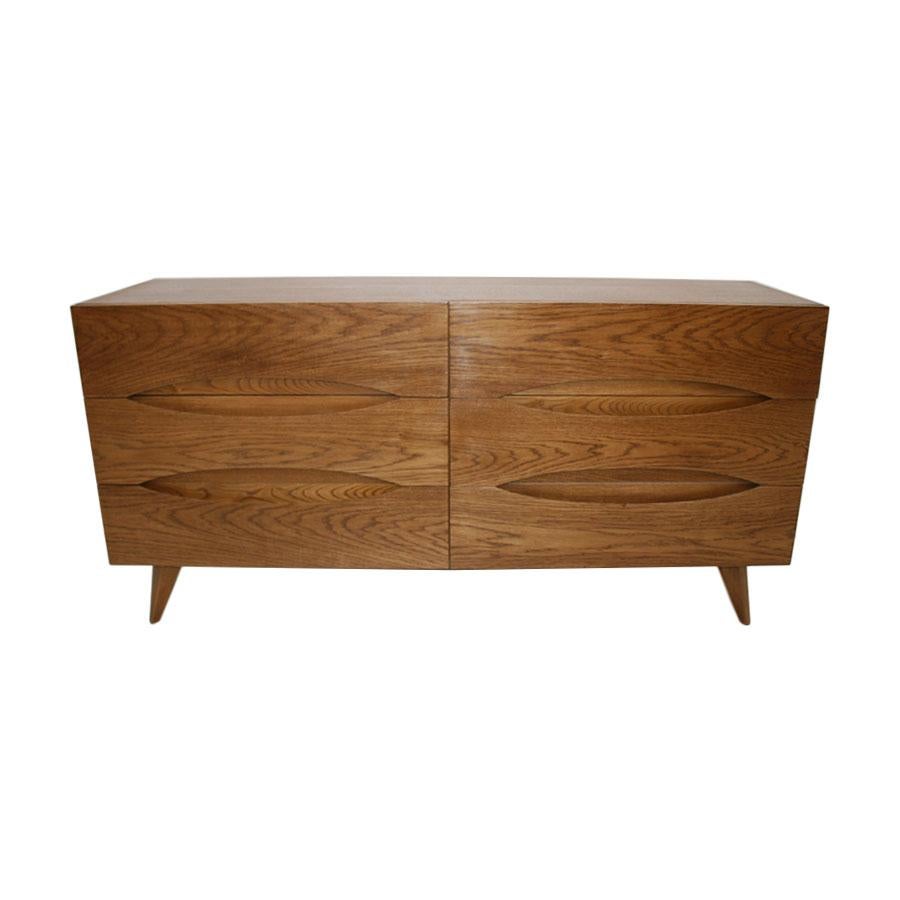 Italian sideboard designed by L.A. Studio. Made of solid wood structure covered in walnut wood. Composed of six drawers, each one with their own embedded handle. Manufactured in Italy.

