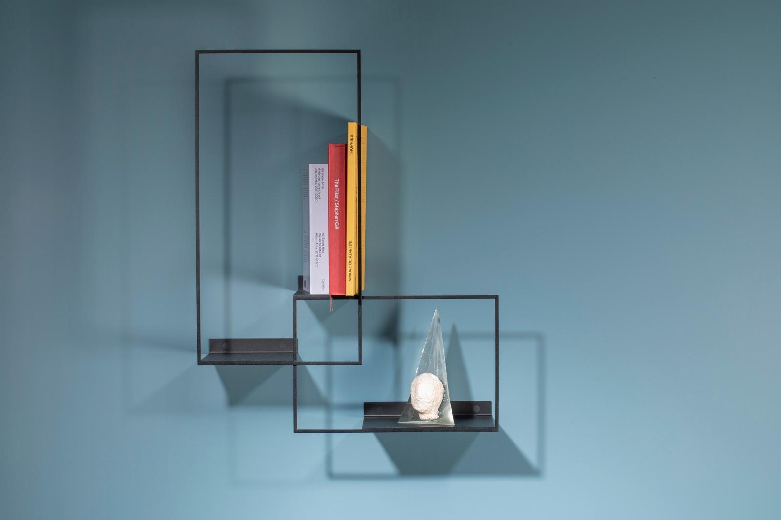 La Superleggera is a hand-welded iron shelf system with a minimal and elegant design. This small version is perfect as storage for entrances or living rooms. 
Its thin lines as drawn by a pencil come to life on the wall in an intertwining of