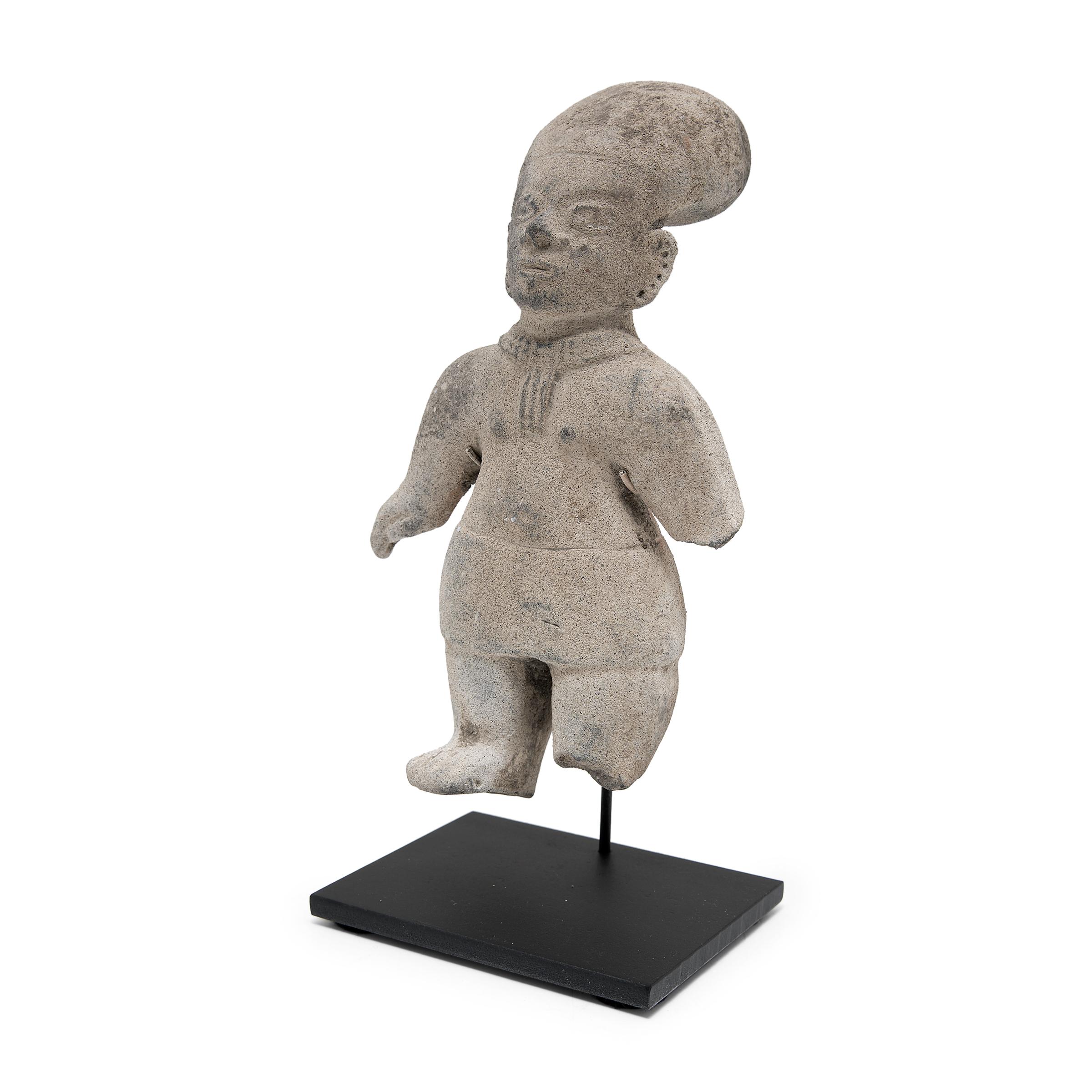 This standing effigy was crafted in 500 A.D. - 1000 A.D. Mesoamerica using the gray clay paste that characterizes La Tolita-Tumaco ceramics of early Colombia-Ecuador. The art of La Tolita-Tumaco civilization is considered one of the most developed