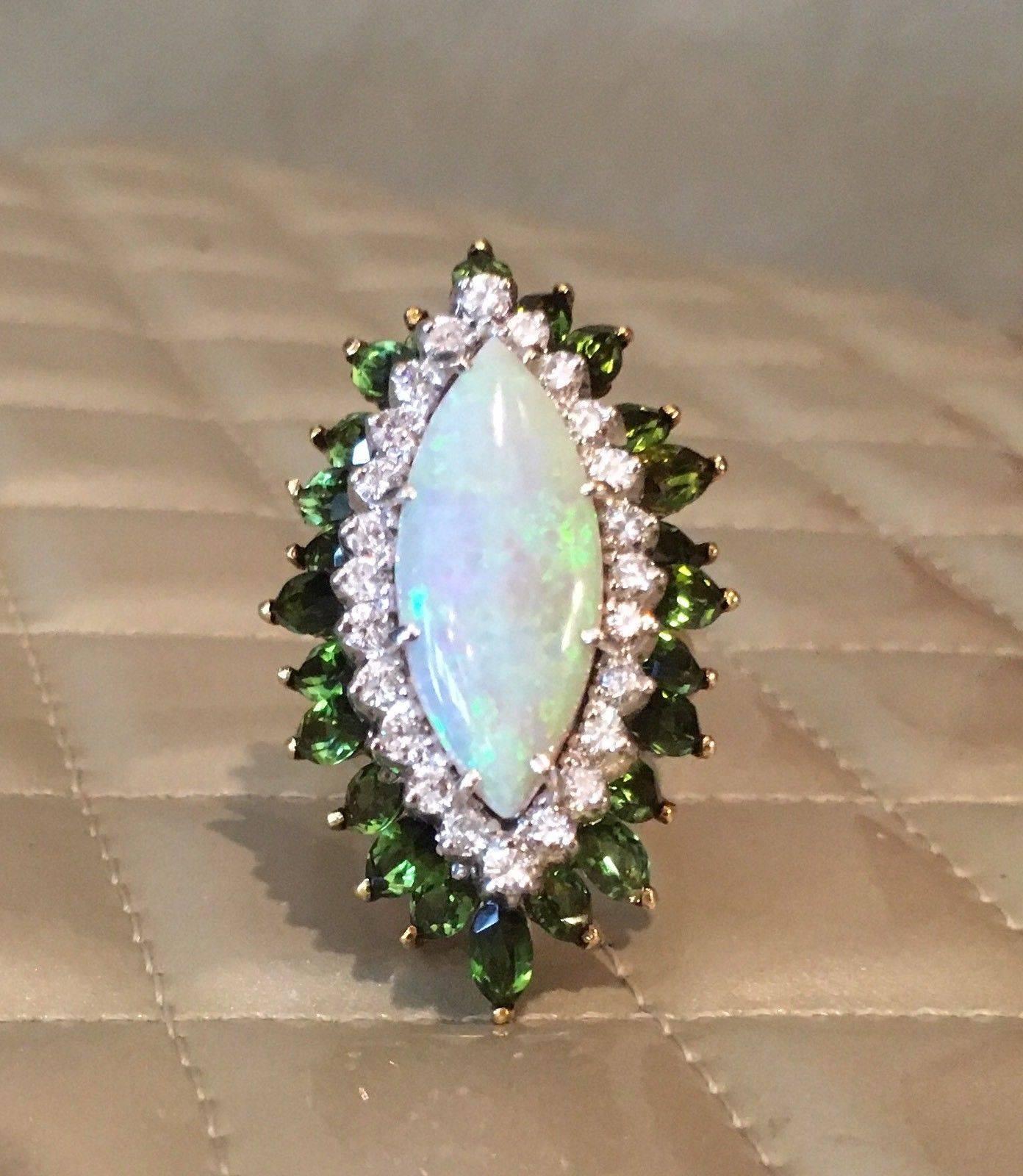 Impressive La Triomphe Designer 18K Yellow Gold Opal Cabochon and 5.28 Cttw Green Tourmaline Diamond Cocktail Ring

This stunning large statement ring features a marquise opal cabochon at he center, with 4.08 carats of marquise green tourmaline set