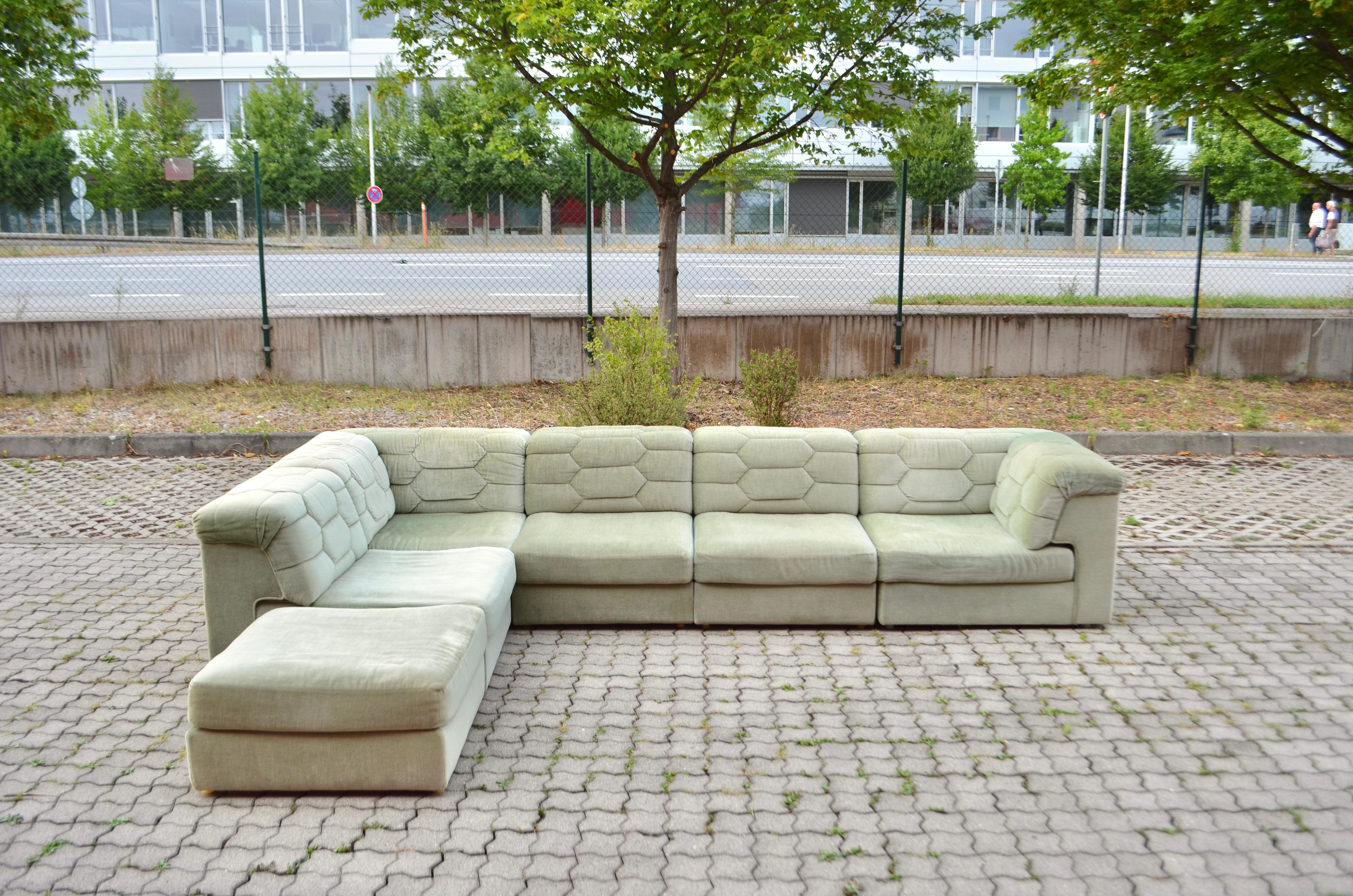 This Modular sectional sofa was manufactured by Laauser in Germany.
It is a pure 70ties design with timeless modern shape.
The fabric is Mohair and has a beautiful pastel green colour.
The frame of every element is made of wood and upholstery in