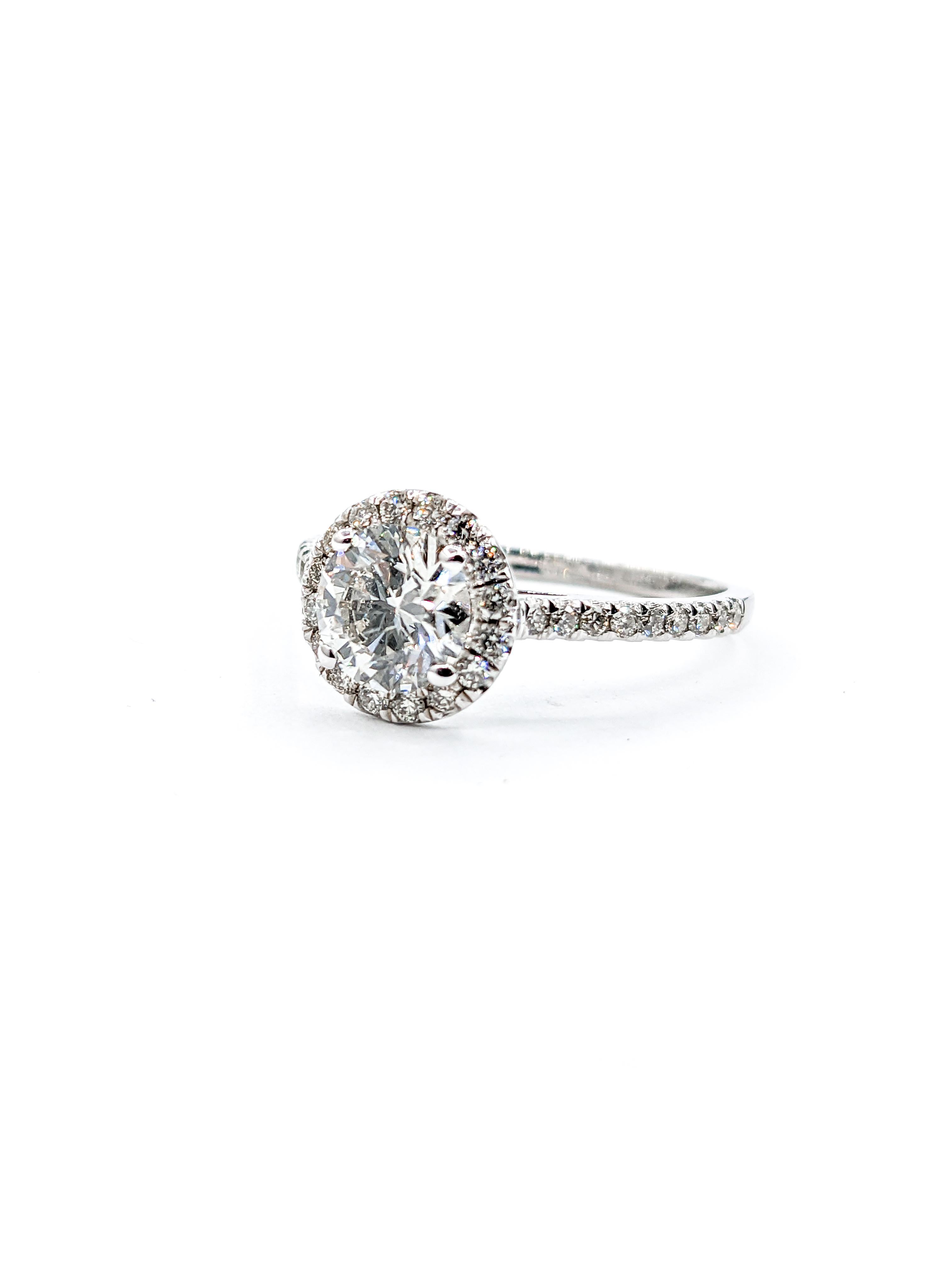 Lab-Created Diamond Halo Engagement Ring in White Gold

Embrace modern elegance with our stunning ring, expertly crafted in 14k white gold. This piece is centered around a dazzling 1.0ct round cut lab-created diamond, known for its SI clarity and