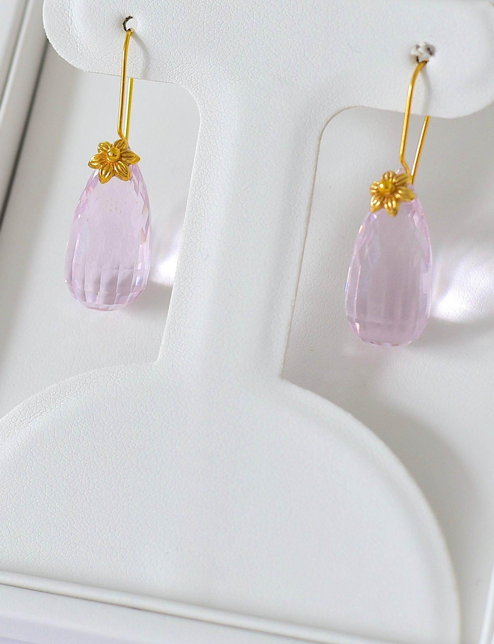 These wonderfully iridescent earrings are small but amazing! 18K solid Yellow Gold earring mounts are elegant, shiny, and timeless. the good price is just a bonus! Lovely soft pink color.

Lab created Pink Kunzite (19mm x 11mm)
18K Solid Yellow