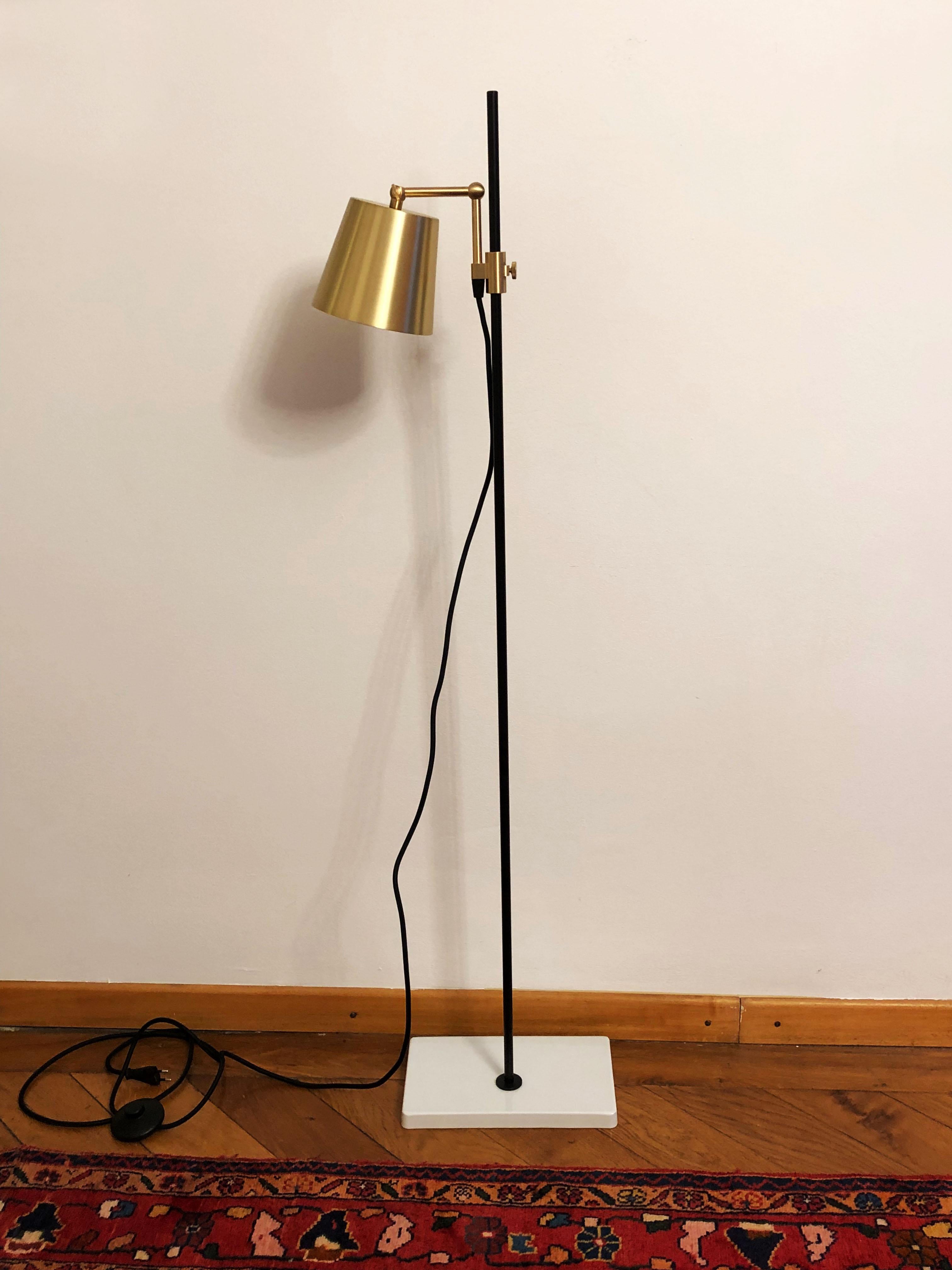 Porcelain base with steel stem and brass aluminum shade. Designed in 2009 by Andrea Kleinloog from Anatomy Design, the Karakter Copenhagen lab floor lamp was inspired by the designer’s parents’ pharmaceutical work and old lab equipment, giving the