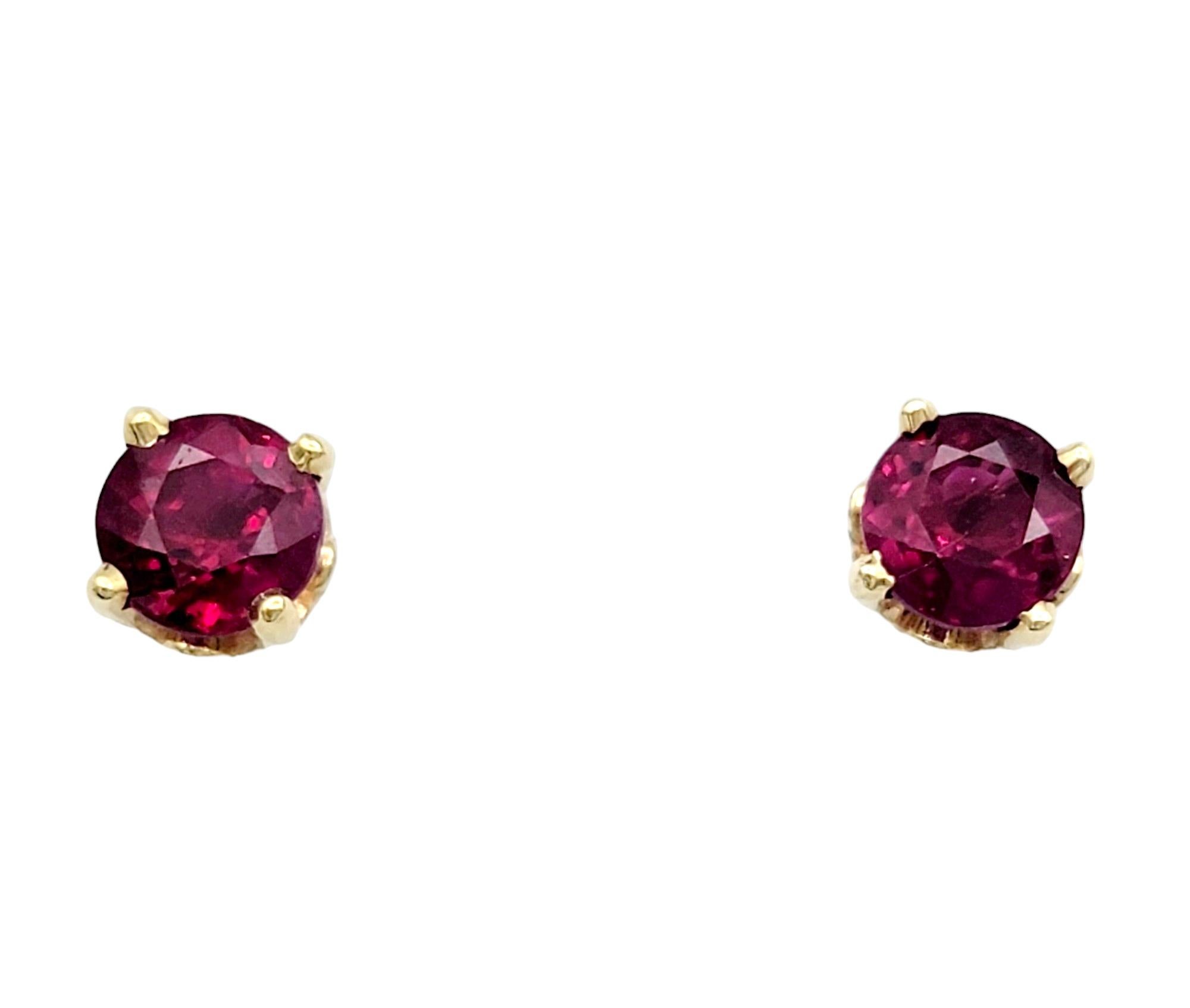 These captivating earrings, set in warm 14 karat yellow gold, feature lab-created red ruby stud earrings as their centerpiece. The ruby studs add a rich and vibrant pop of color, symbolizing passion and elegance. To enhance their allure, a jacket 