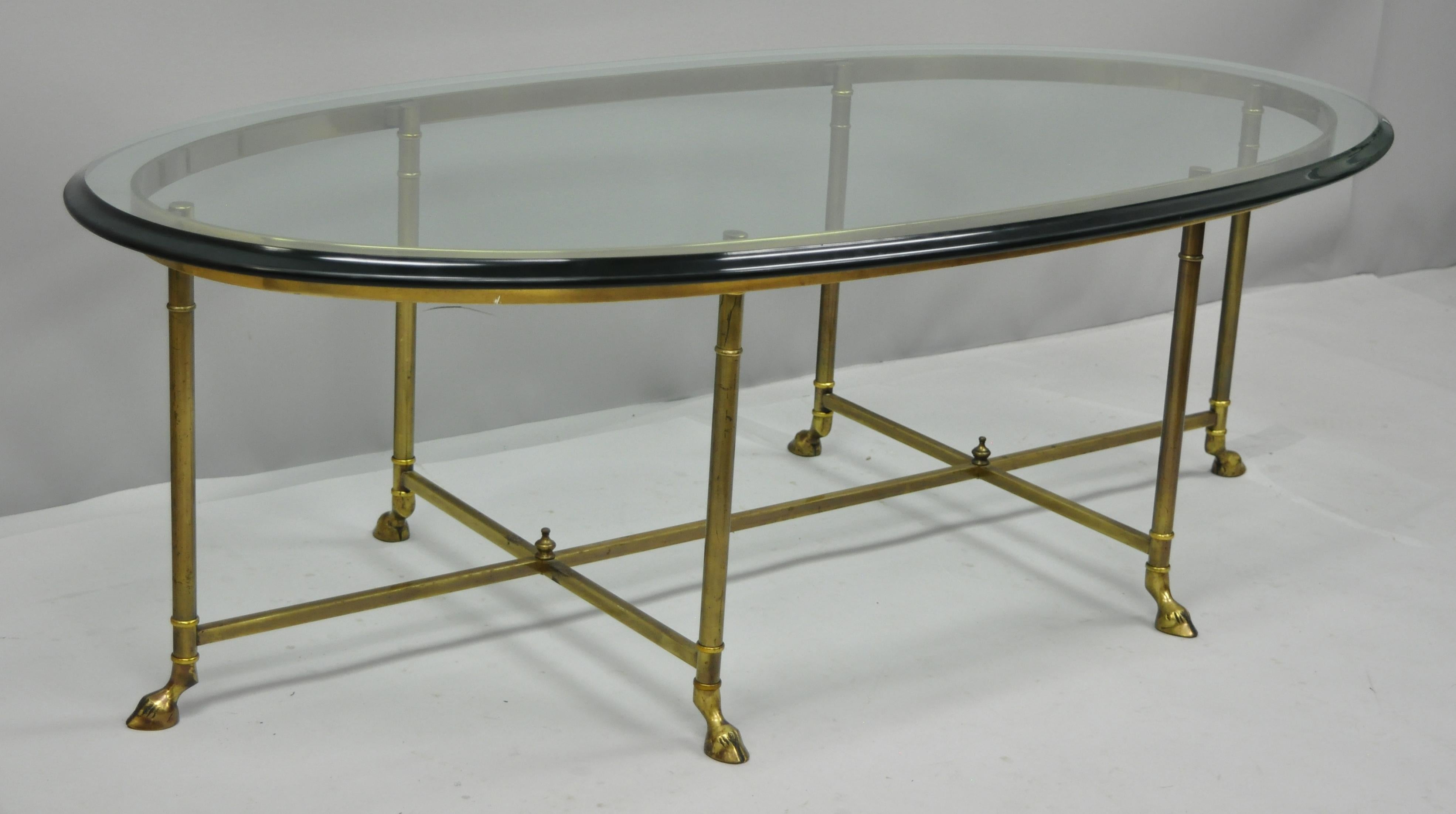 Brass and glass oval Italian coffee table with hoof feet by Labarge. Item features a rare style with 6 legs and hoof feet, thick oval beveled glass, and brass frame, circa mid-late 20th century. Measurements: 17