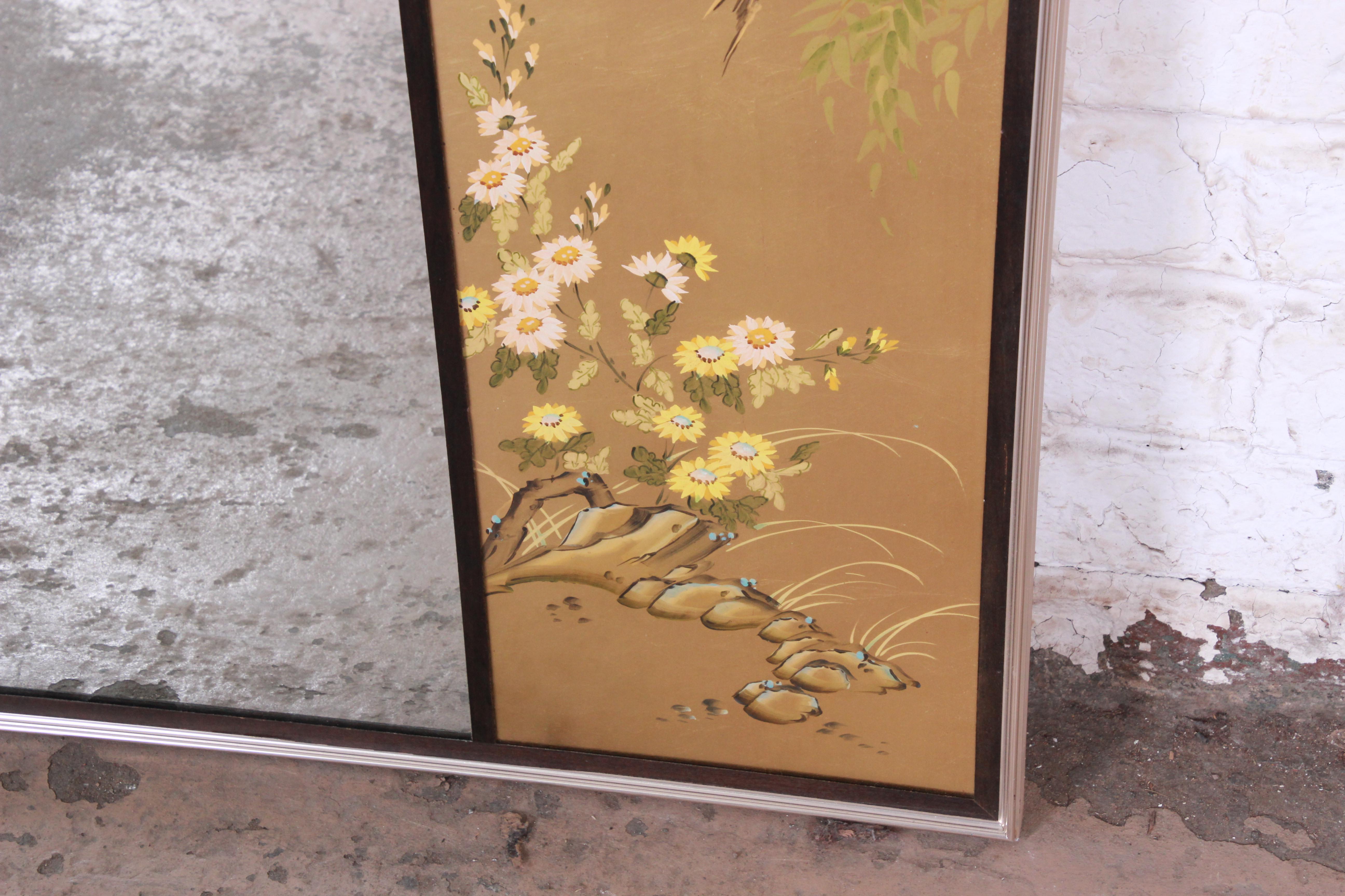A stunning Labarge églomisé beveled mirror. The mirror features a reverse painted floral Asian scenery design on a gold background. Markings include artist's signature to bottom right corner along the border, as well as manufacturers label, fixed to